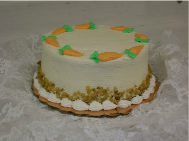 A small cake with carrots on top of it