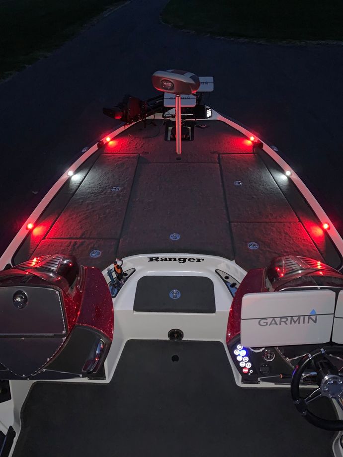 The front of a garmin boat is lit up at night