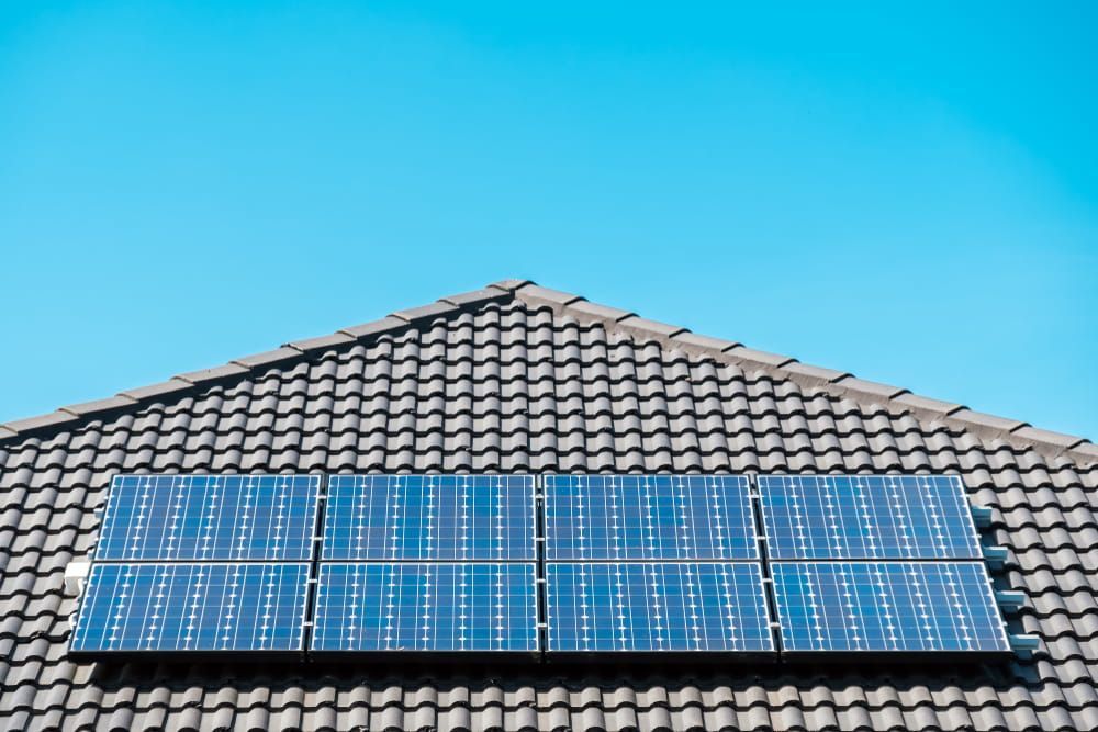 A Row of Solar Panels on the Roof of a House — Cool Heat Air Conditioning in Kiama, NSW