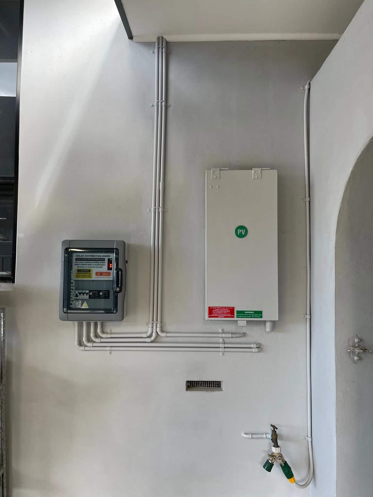 A White Wall With a Box on It and a Hose Attached to It — Cool Heat Air Conditioning in Albion Park, NSW
