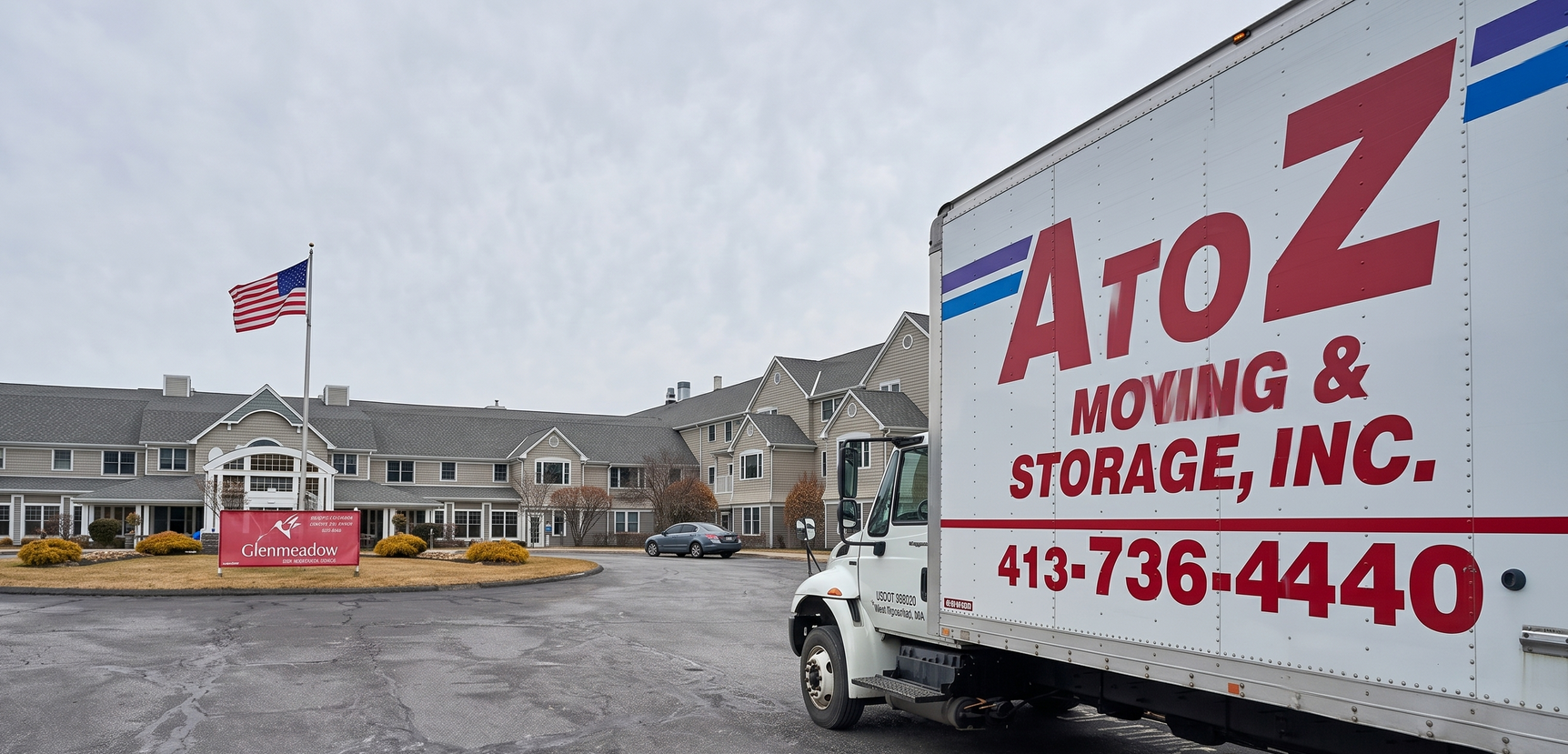 AtoZ Moving & Storage building with large red sign and parked trucks on a snowy lot