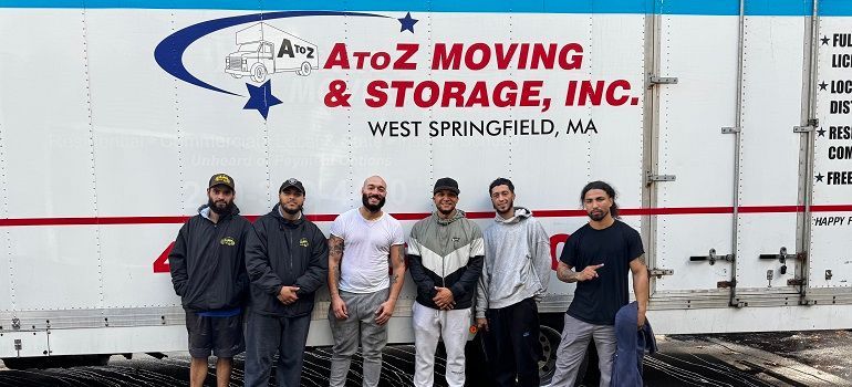 Five people standing in front of a white A to Z Moving & Storage truck in West Springfield, MA