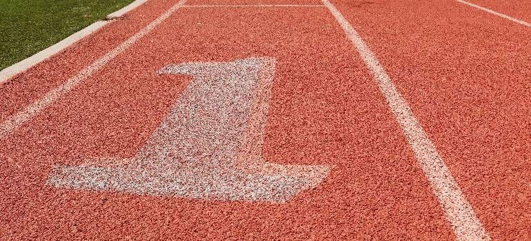 White number 1 on a red running track lane