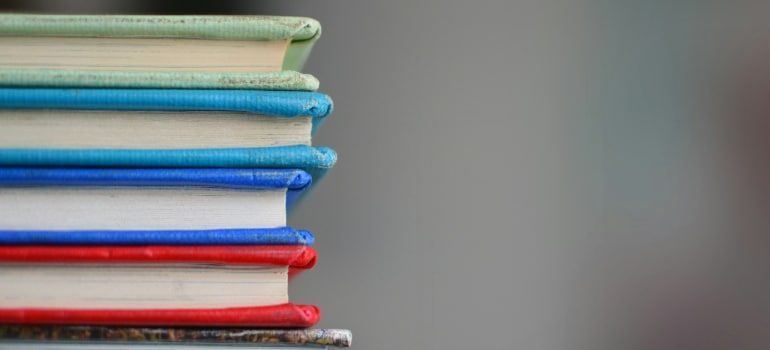 Stack of colorful notebooks on a table with a blurred background