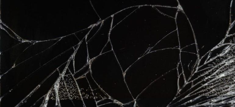 Abstract dark image with white cracks or web-like lines across a black background