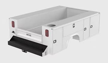 White service truck bed with side compartments and drop-down tailgate.