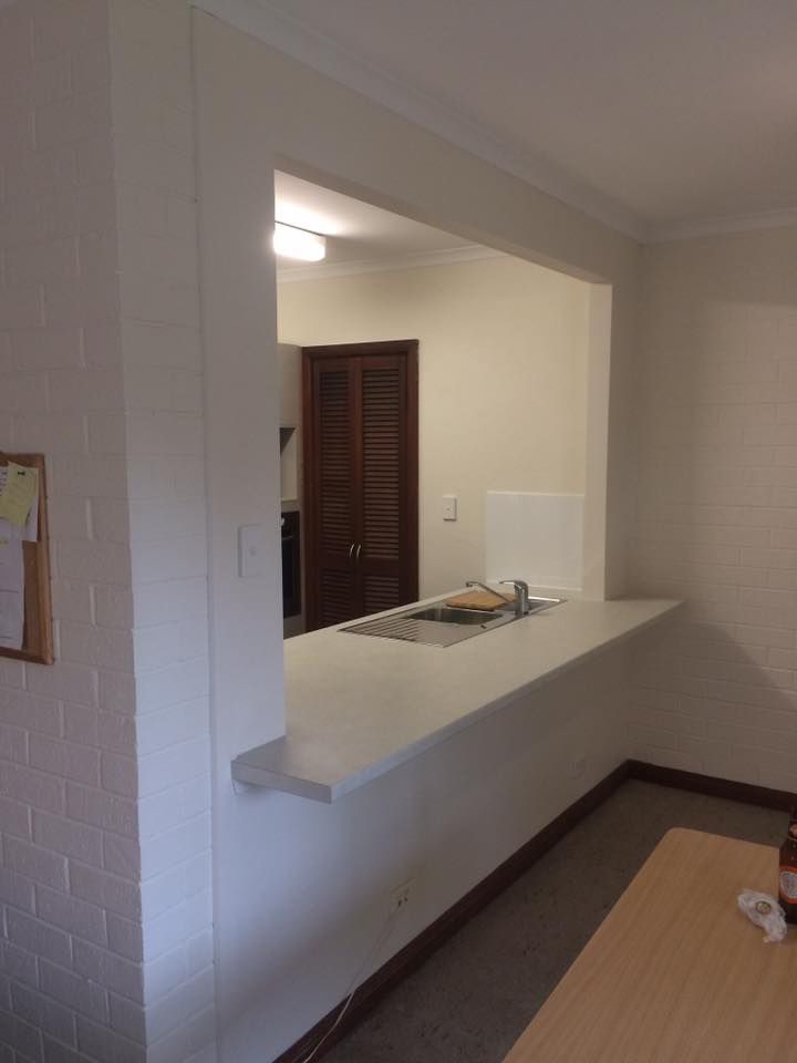 A Kitchen with A Counter and A Table in A Living Room — P & M Maintenance Building Services in Yass River, NSW