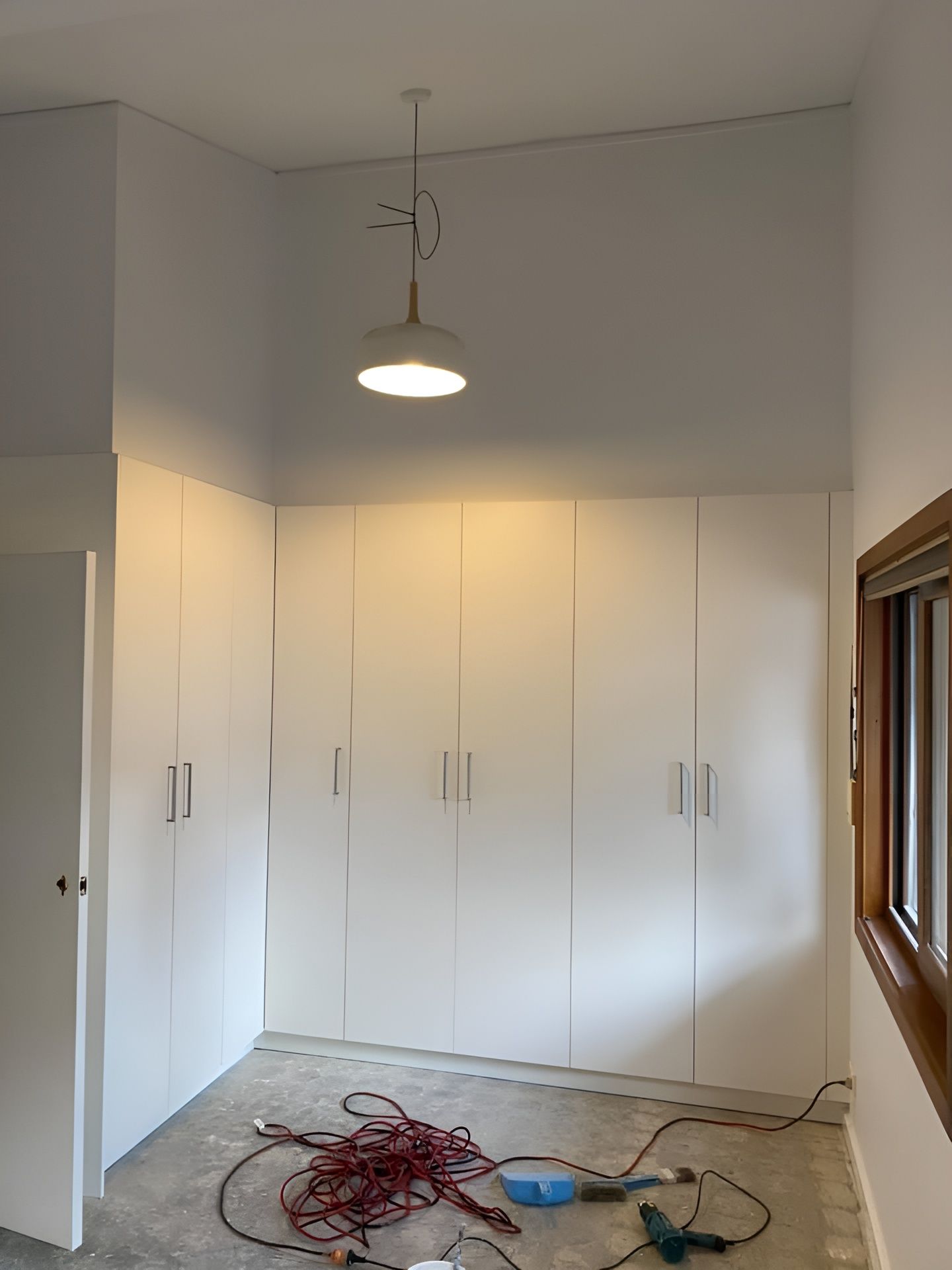 A Bedroom with White Cabinets and A Bed — P & M Maintenance Building Services in Yass River, NSW
