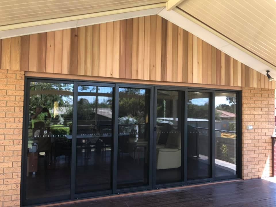 A House with A Lot of Windows and A Wooden Siding — P & M Maintenance Building Services in Yass River, NSW