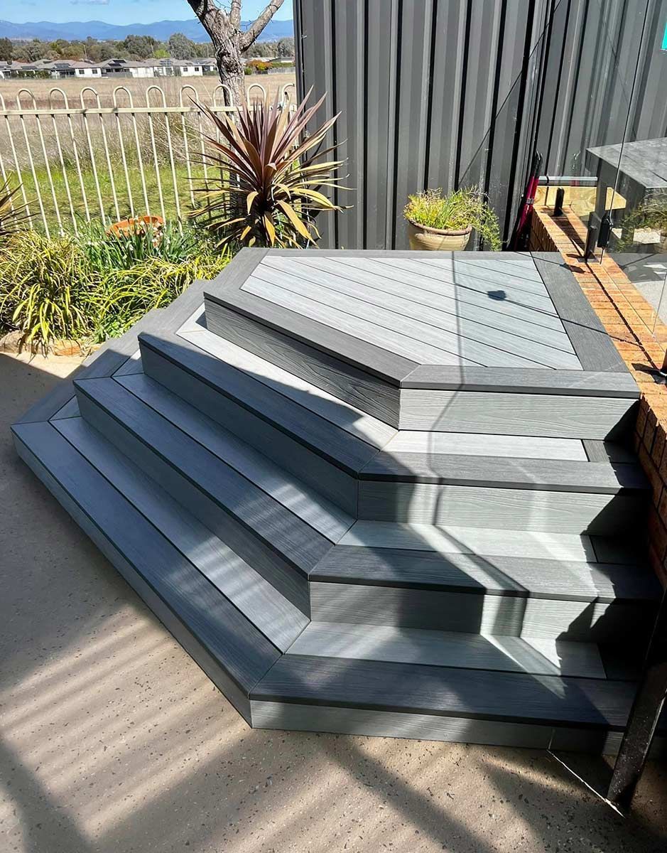 A Set of Stairs Leading up To a Deck with A Fence in The Background — P & M Maintenance Building Services in Yass, NSW