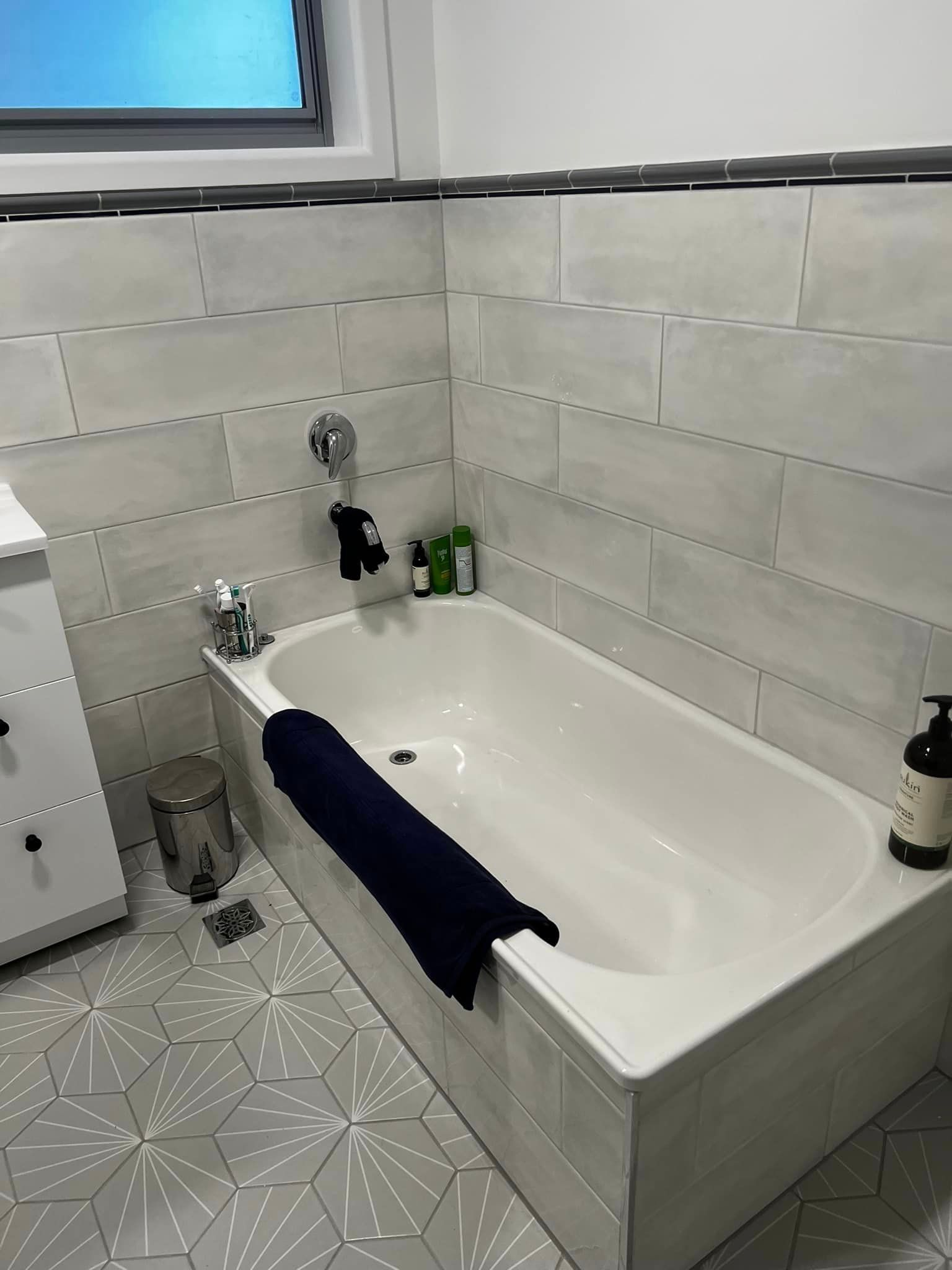 A Bathroom With A Bathtub, Sink, And Window — P & M Maintenance Building Services In Yass River, NSW