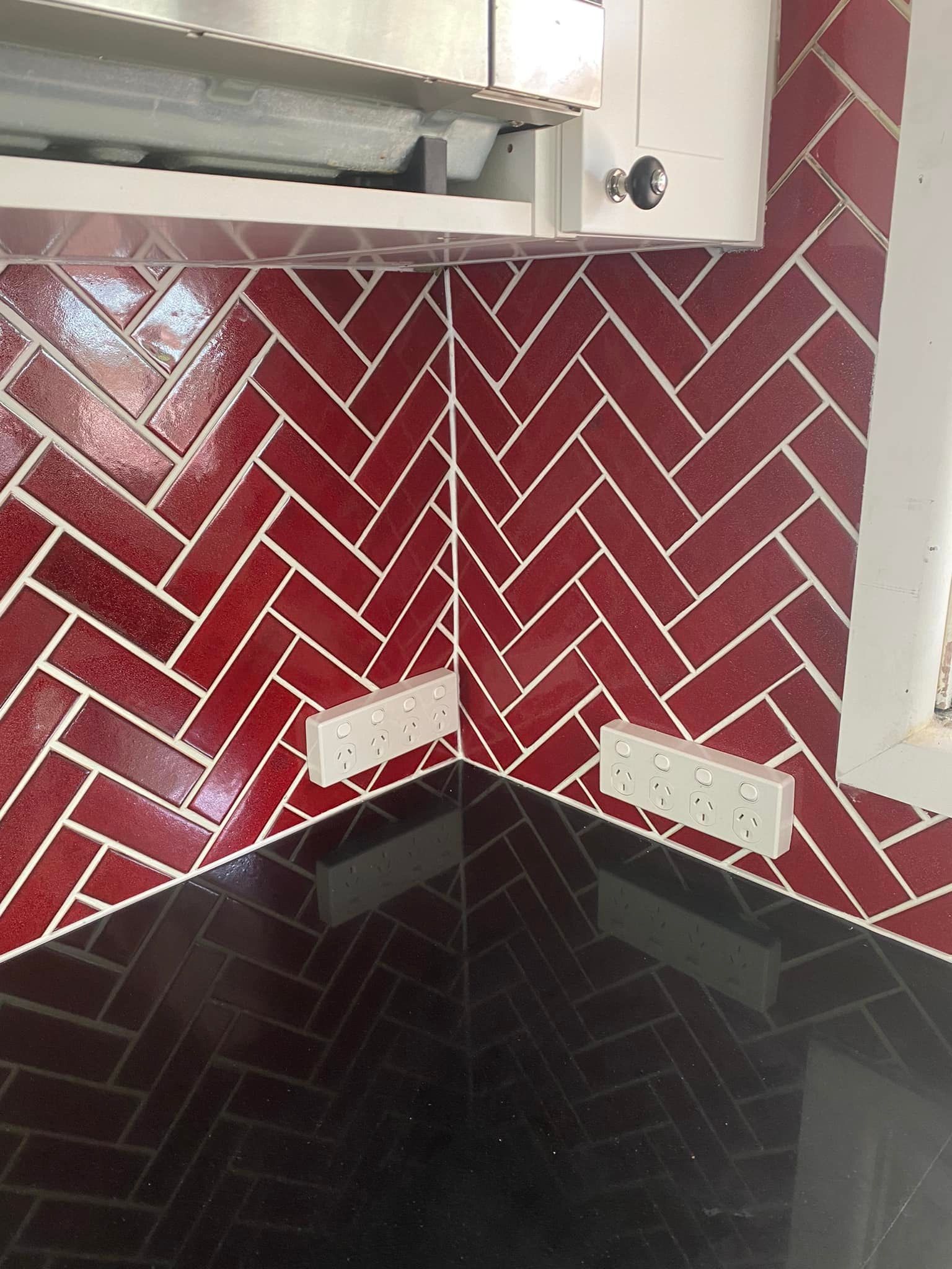 A Kitchen with Red Tiles in A Herringbone Pattern — P & M Maintenance Building Services in Yass River, NSW