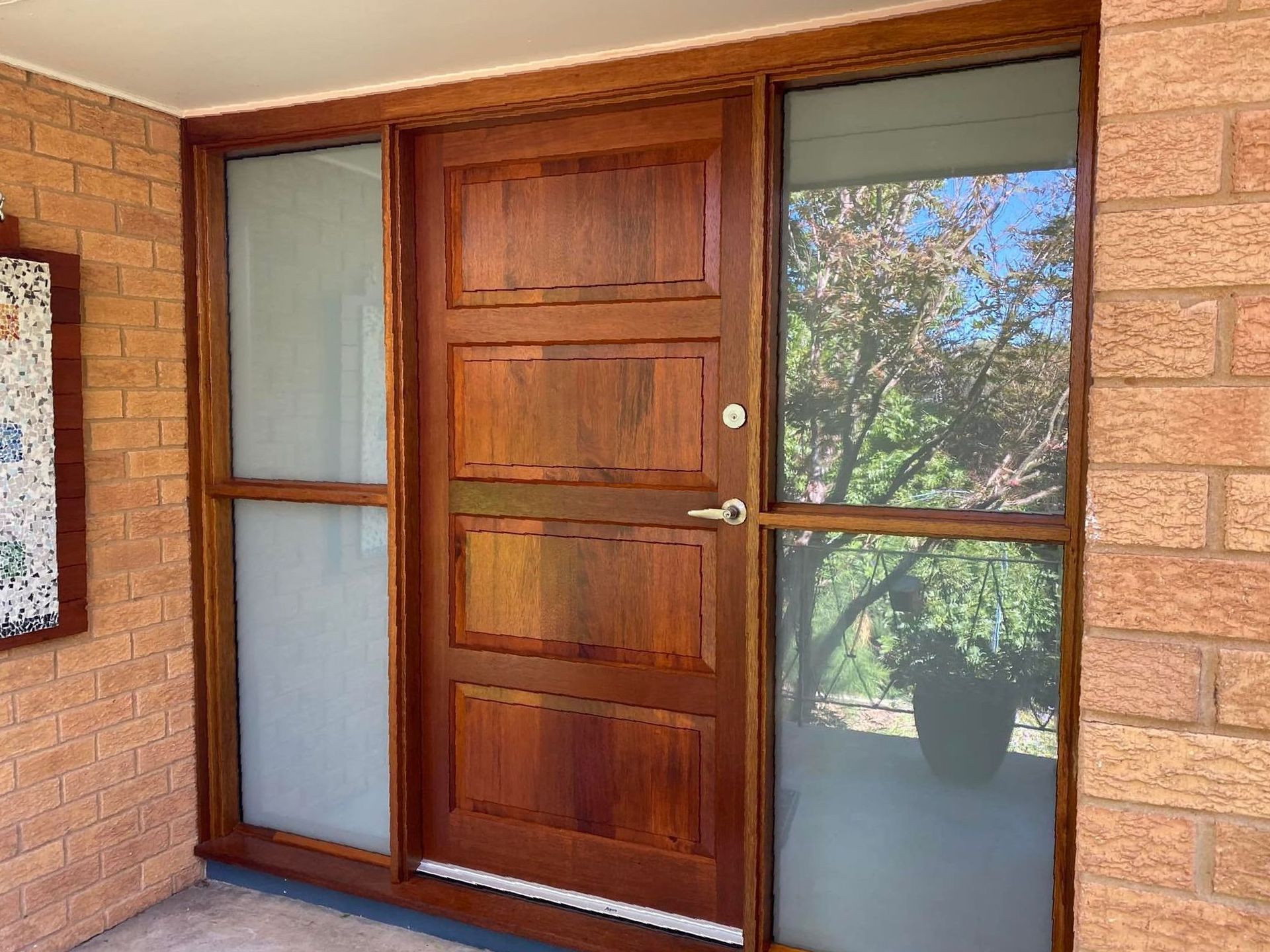 A Wooden Door with A Lot of Windows Is on A Brick Wall — P & M Maintenance Building Services in Yass, NSW