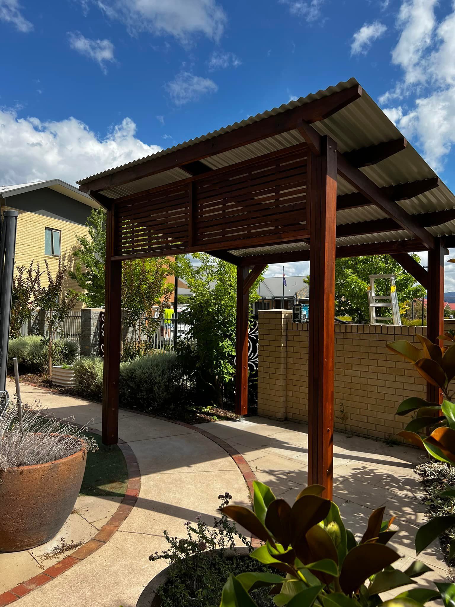 A Blue Deck with A Pergola on Top of It — P & M Maintenance Building Services in Belconnen, ACT