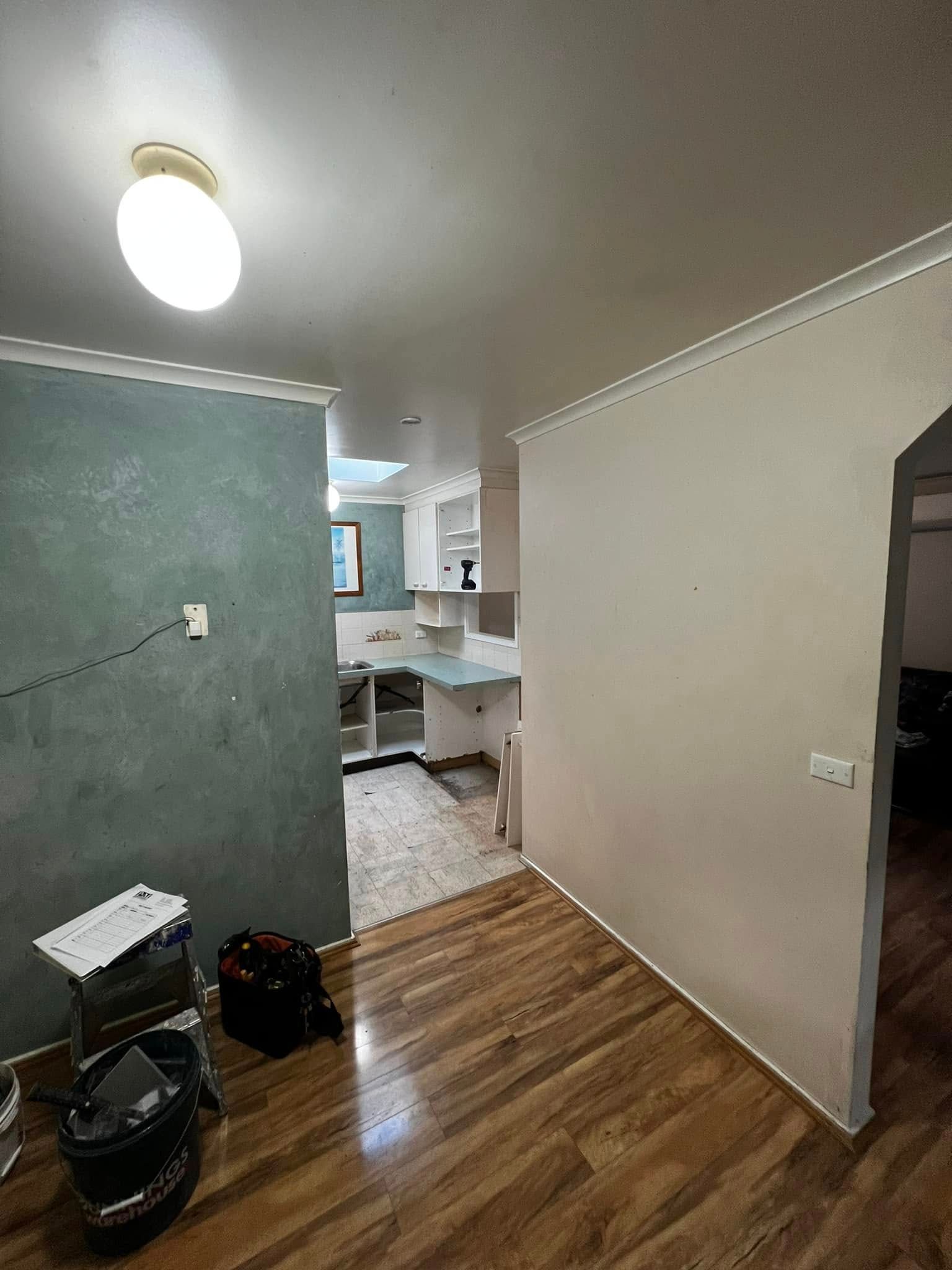 A Living Room with Hardwood Floors and A Ceiling Light — P & M Maintenance Building Services in Yass River, NSW