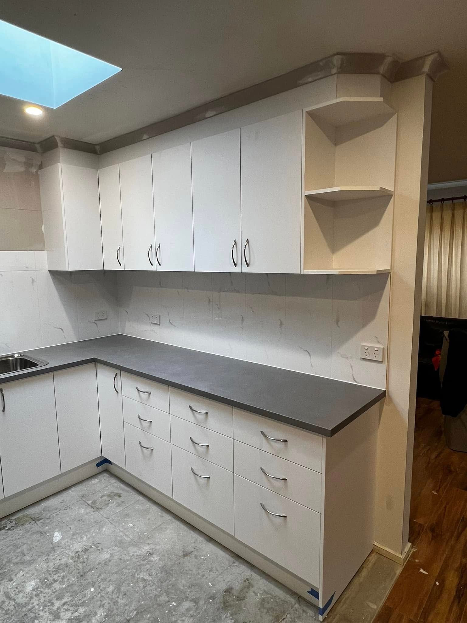 A Kitchen with White Cabinets and A Gray Counter Top — P & M Maintenance Building Services in Yass River, NSW