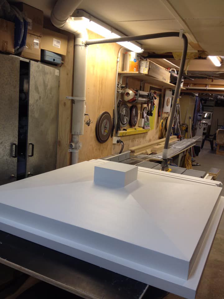 A Large White Piece of Wood Is Sitting on A Table in A Workshop — P & M Maintenance Building Services in Gungahlin, ACT