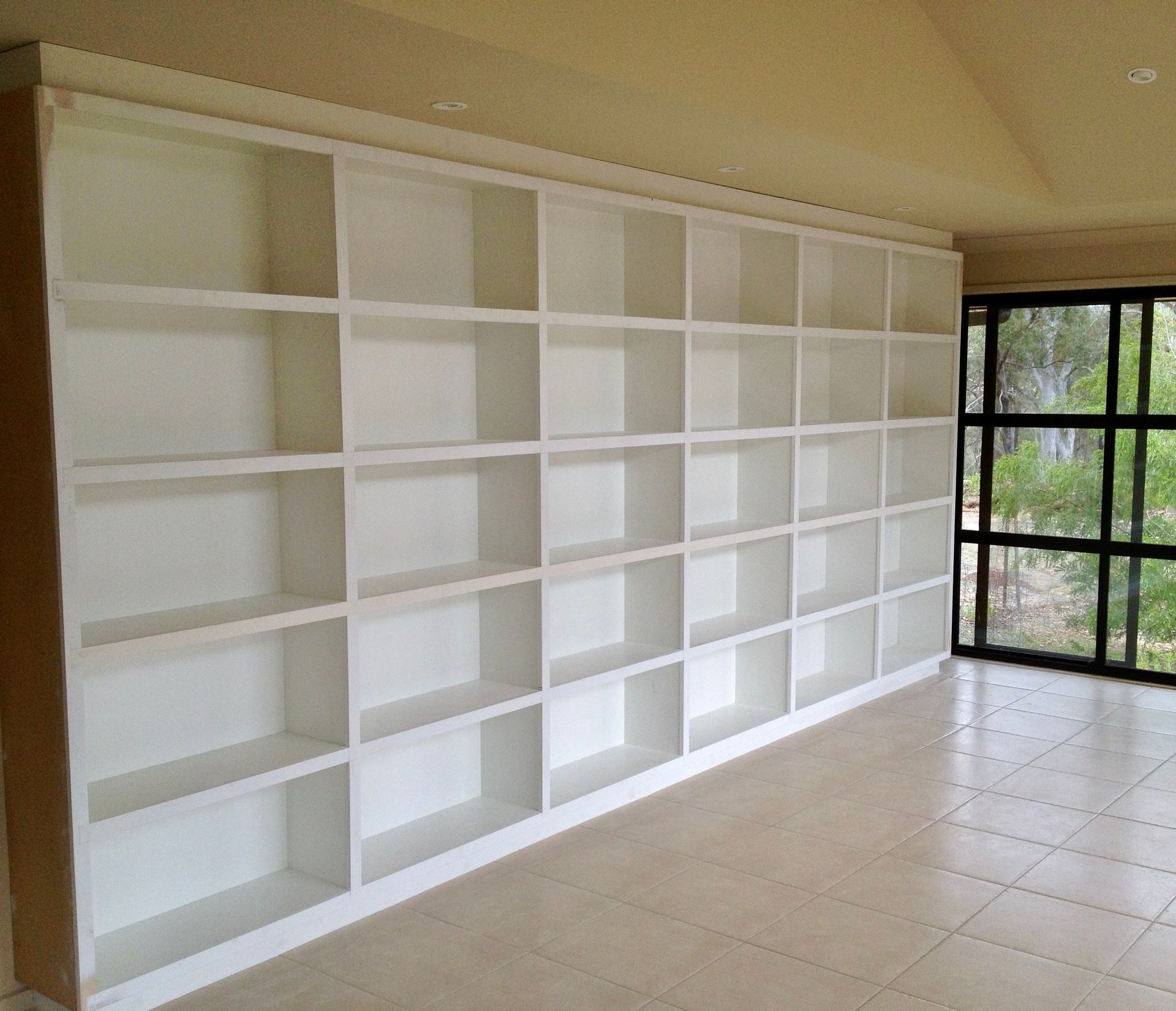 A Room with A Lot of Shelves and A Window — P & M Maintenance Building Services in Yass, NSW