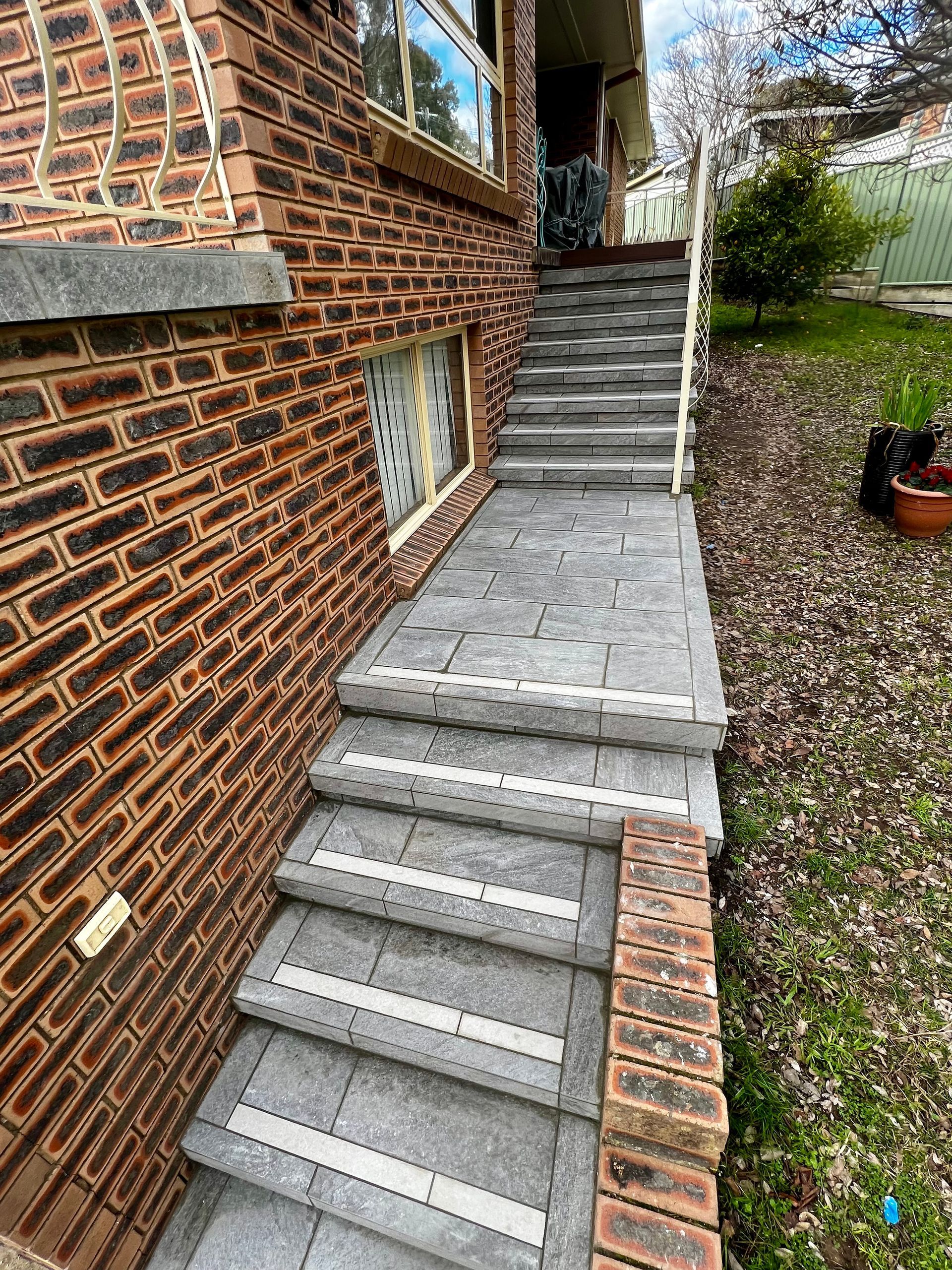 A Set of Stairs Leading up To a Brick Building — P & M Maintenance Building Services in Yass River, NSW