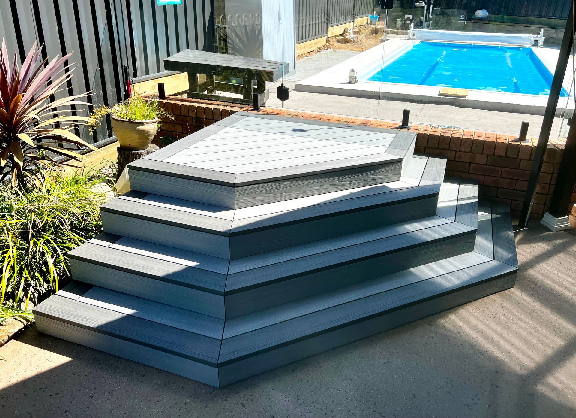 A Stack of Stairs Next to A Swimming Pool — P & M Maintenance Building Services in Gungahlin, ACT