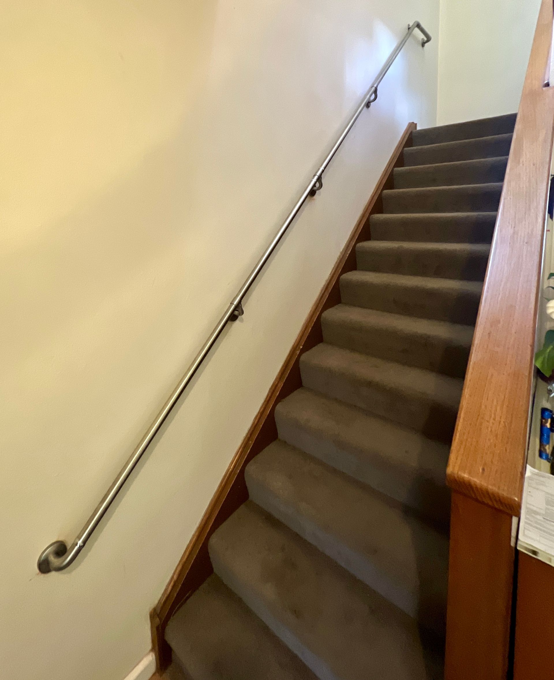 A Staircase with A Wooden Railing and Carpeted Steps in A House — P & M Maintenance Building Services in Yass River, NSW