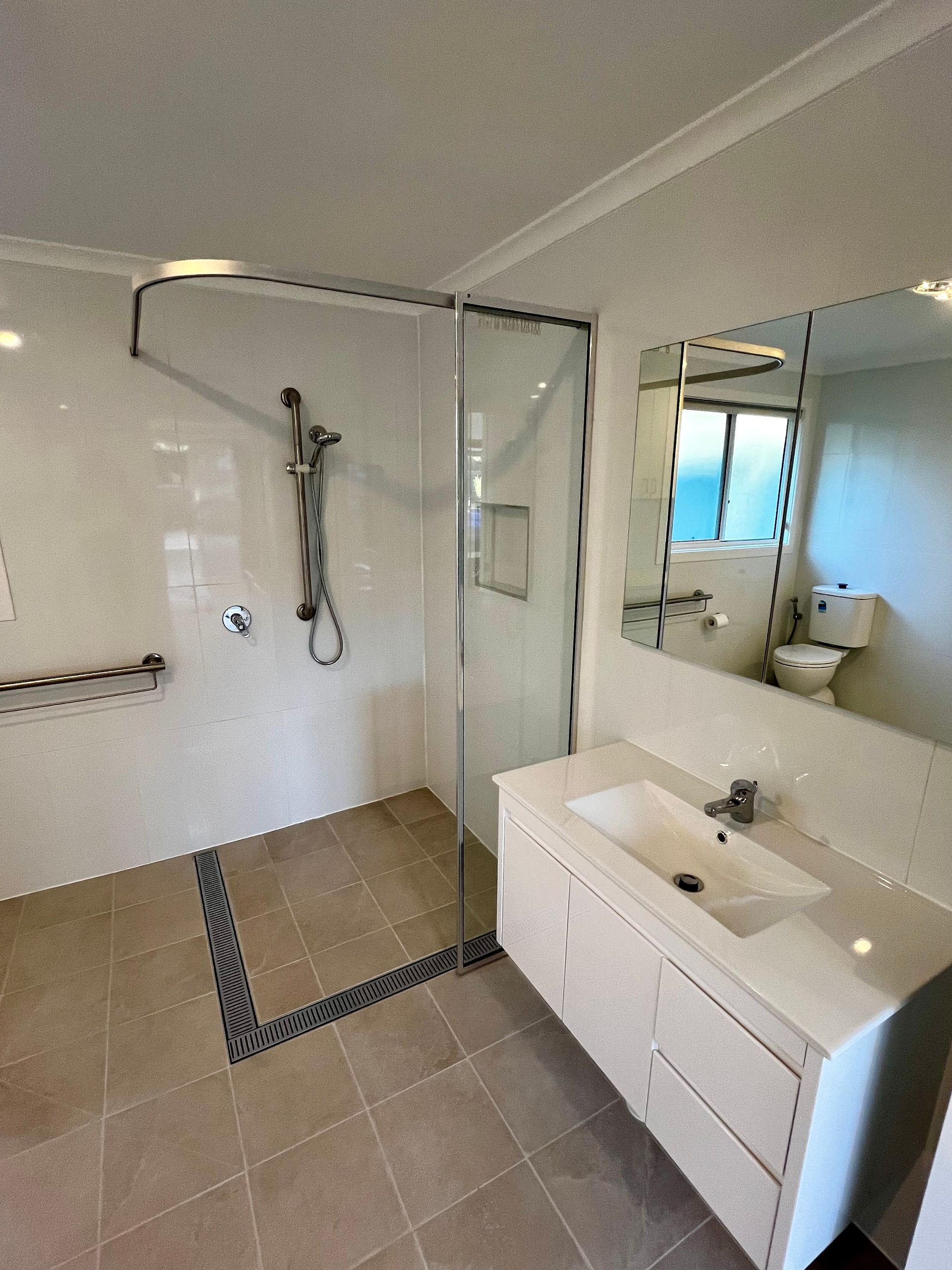 An Accessible Shower And Sink In A Bathroom — P & M Maintenance Building Services in Yass River, NSW