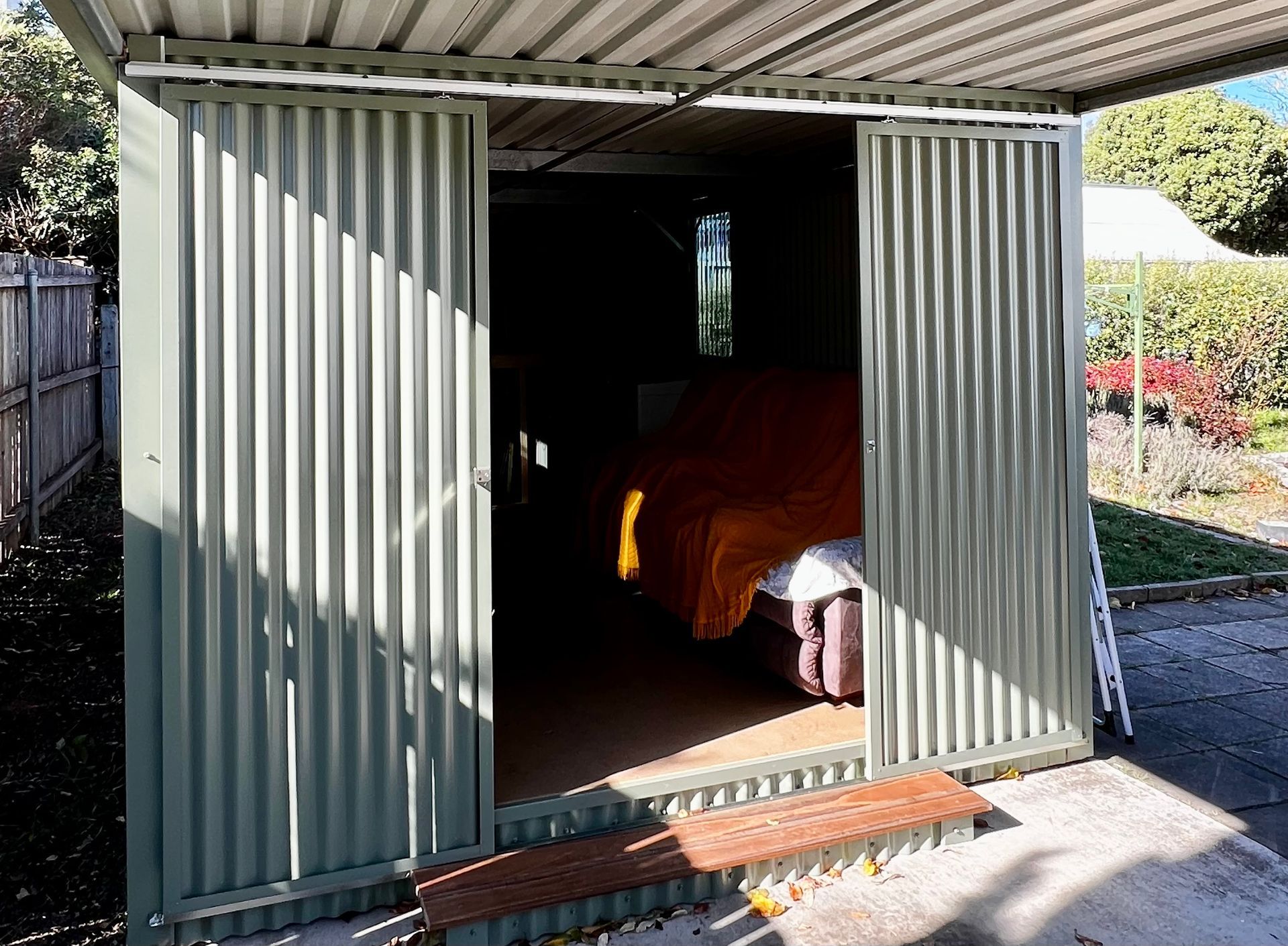 A Garage with The Doors Open and A Car Inside — P & M Maintenance Building Services in Yass River, NSW