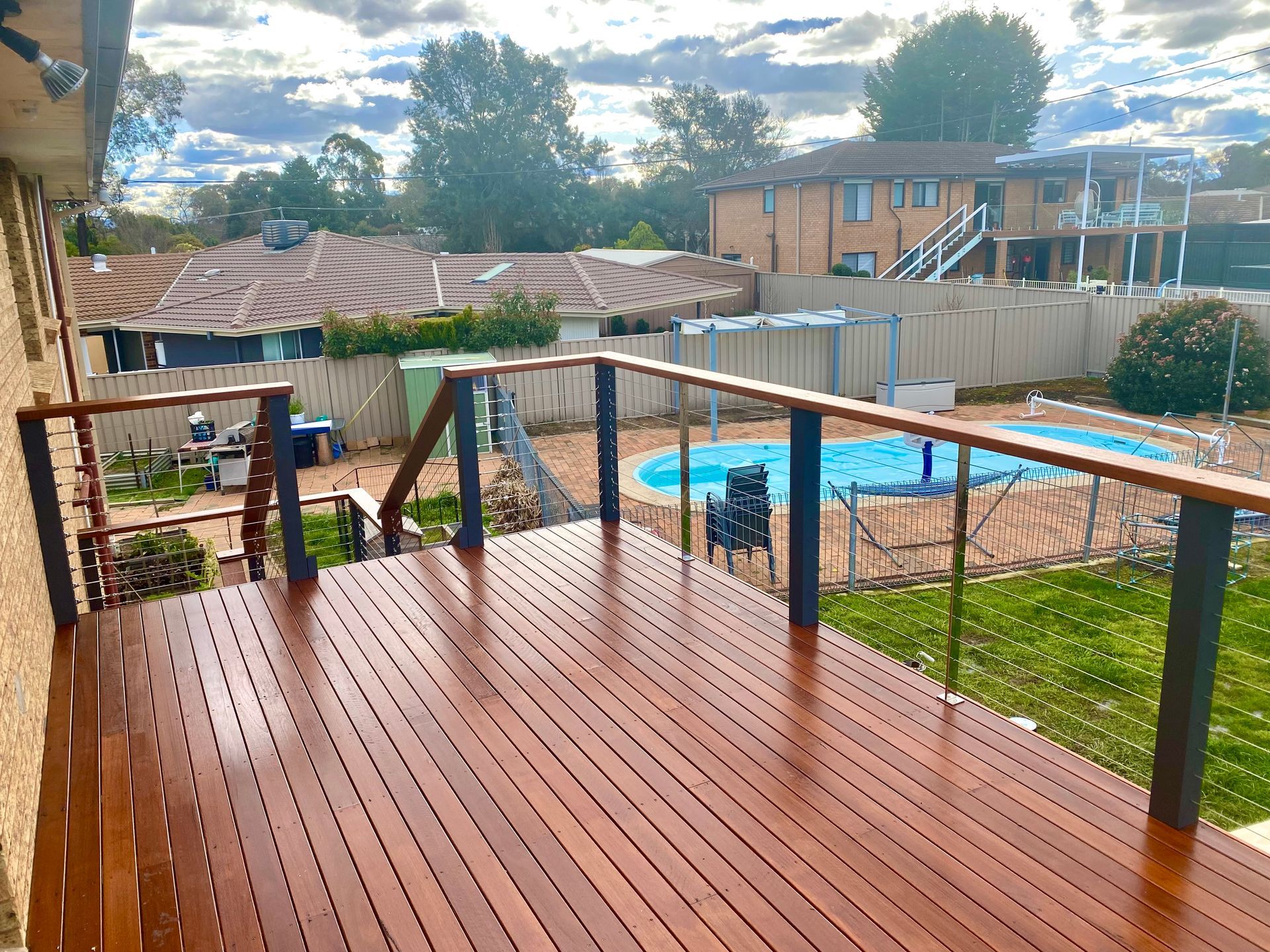 A Deck with Stairs Leading Down to A Pool — P & M Maintenance Building Services in Belconnen, ACT