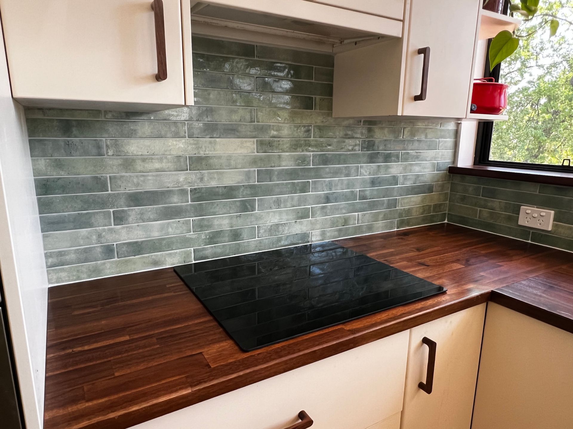 A Kitchen with A Stove Top Oven and Wooden Counter Tops — P & M Maintenance Building Services in Murrumbateman, NSW