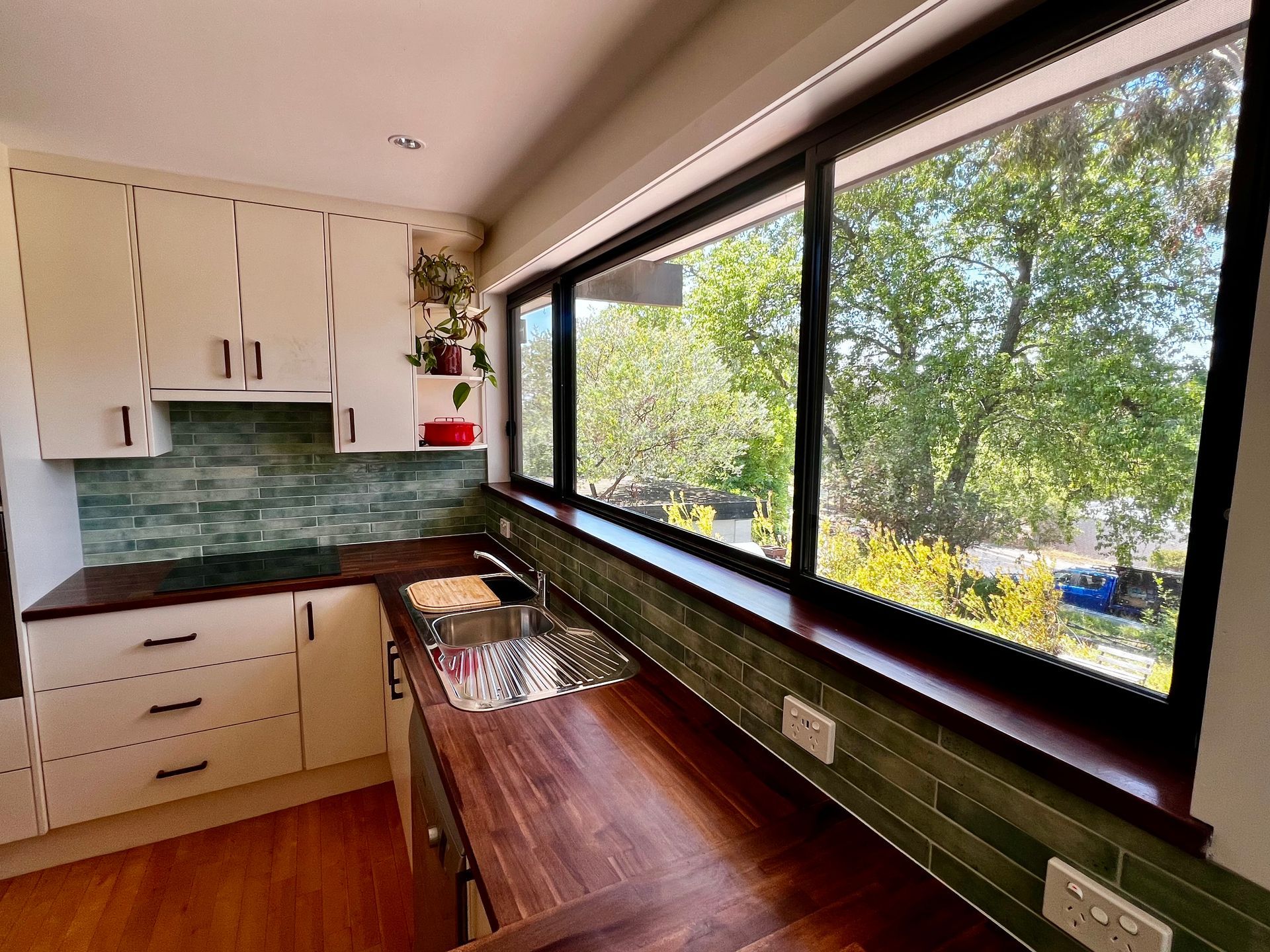 A Renovated Kitchen With Wooden Bench Tops — P & M Maintenance Building Services in Yass River, NSW