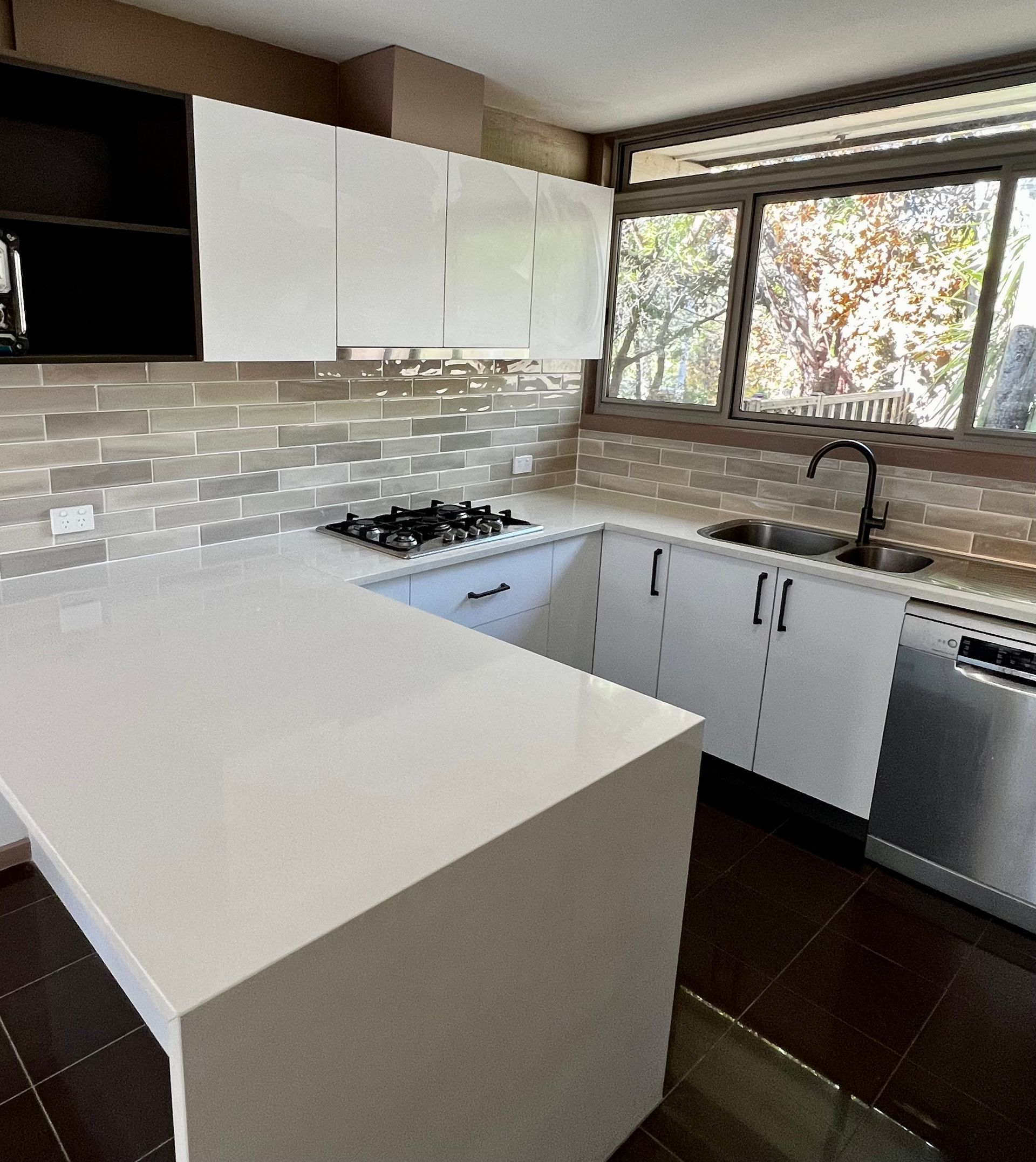 A Kitchen with White Cabinets and Stainless Steel Appliances — P & M Maintenance Building Services in Murrumbateman, NSW