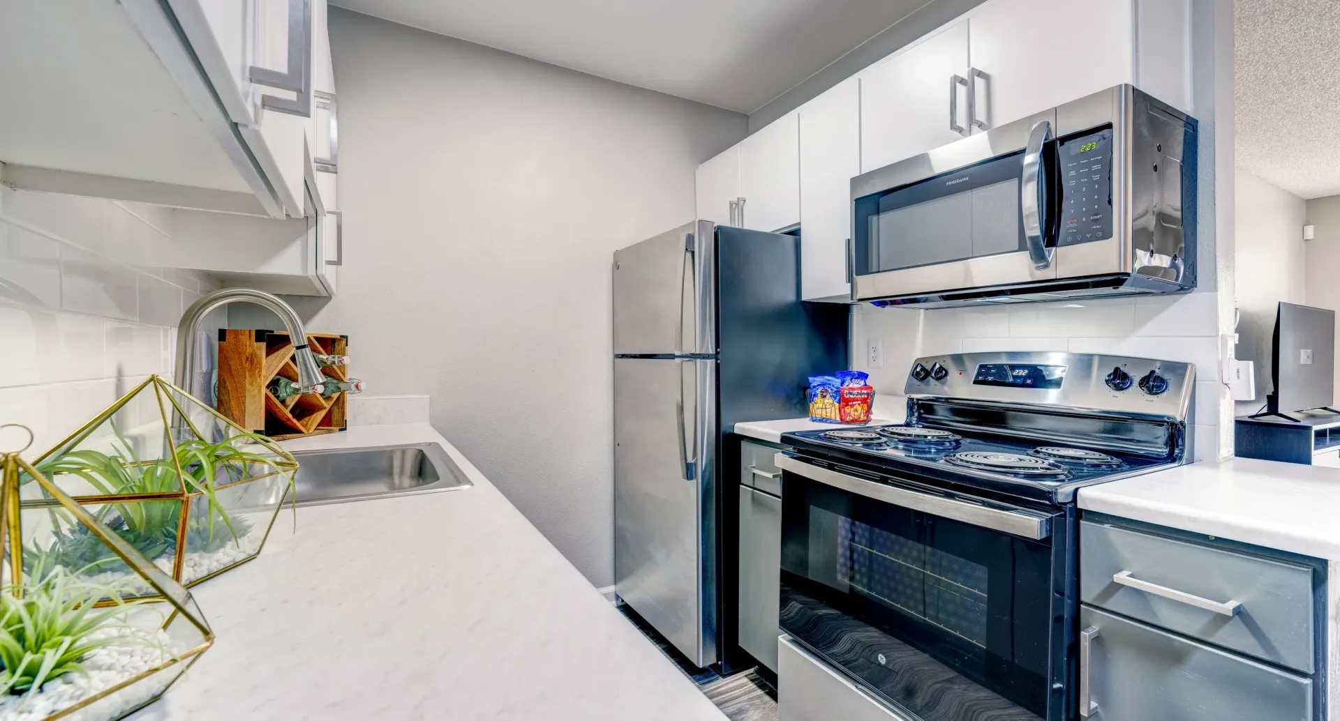 Modern kitchen with stainless steel appliances and granite countertops.