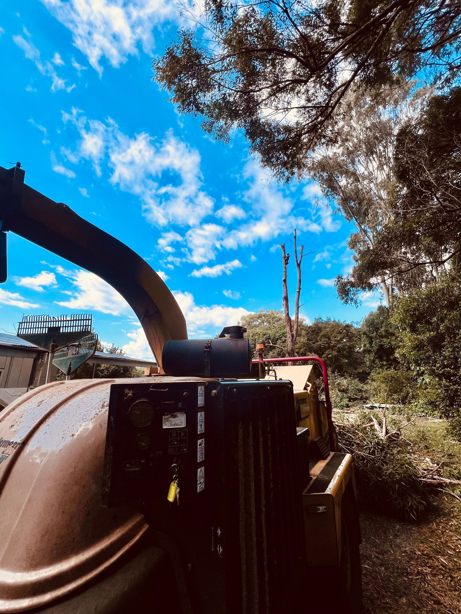 Wood Chipper Under a Bright Blue Sky with Scattered Clouds — AAA Trees On Tweed in Tyalgum, NSW