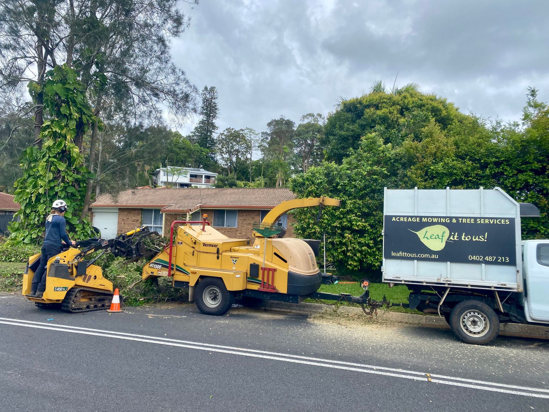 A Tree Service Crew Using Equipment on A Roadside to Remove Tree Debris — AAA Trees On Tweed in Suffolk Park, NSW
