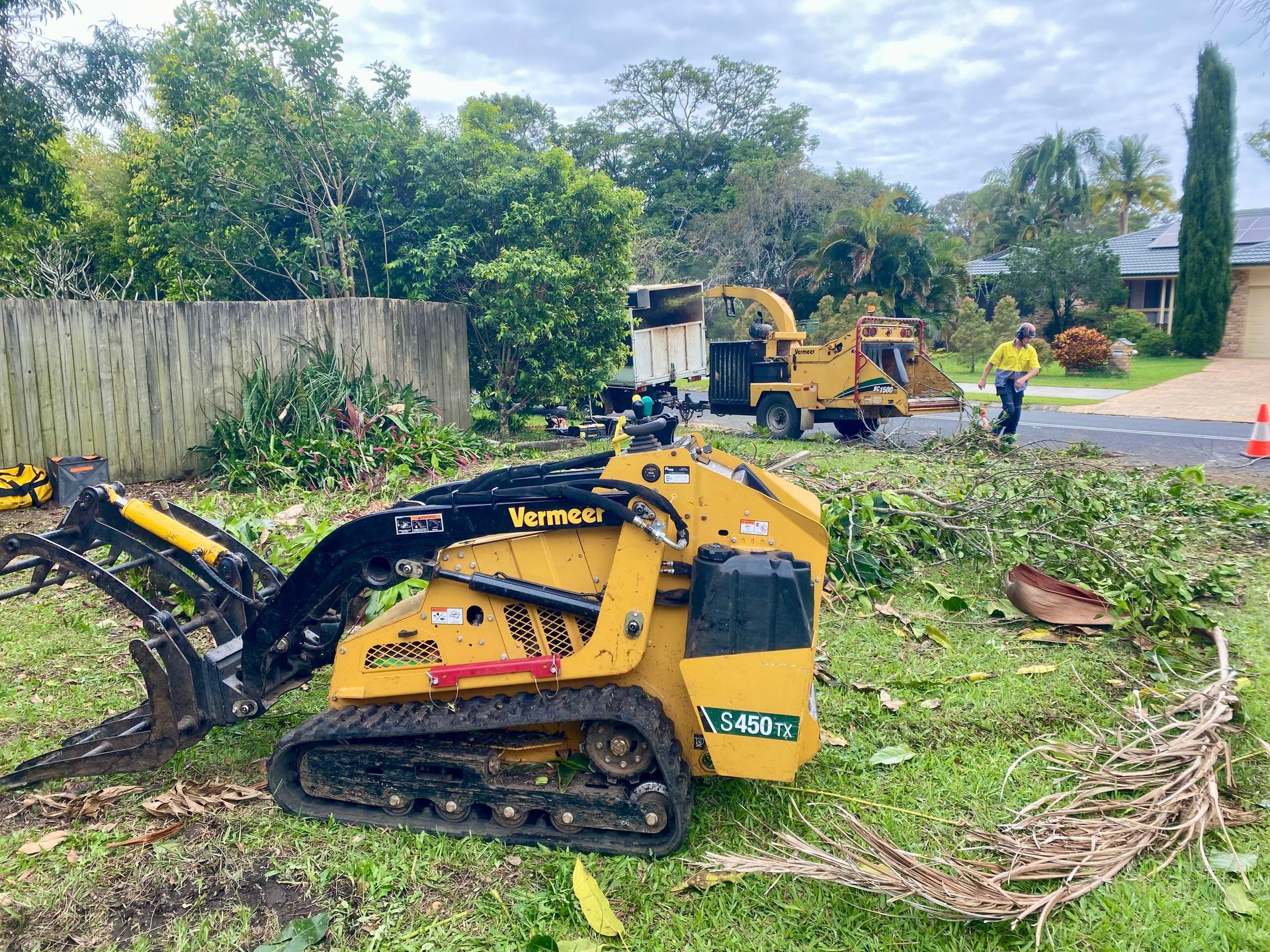 Yellow Vermeer Mini Skid Steer and Chipper in A Yard — AAA Trees On Tweed in Murwillumbah, NSW