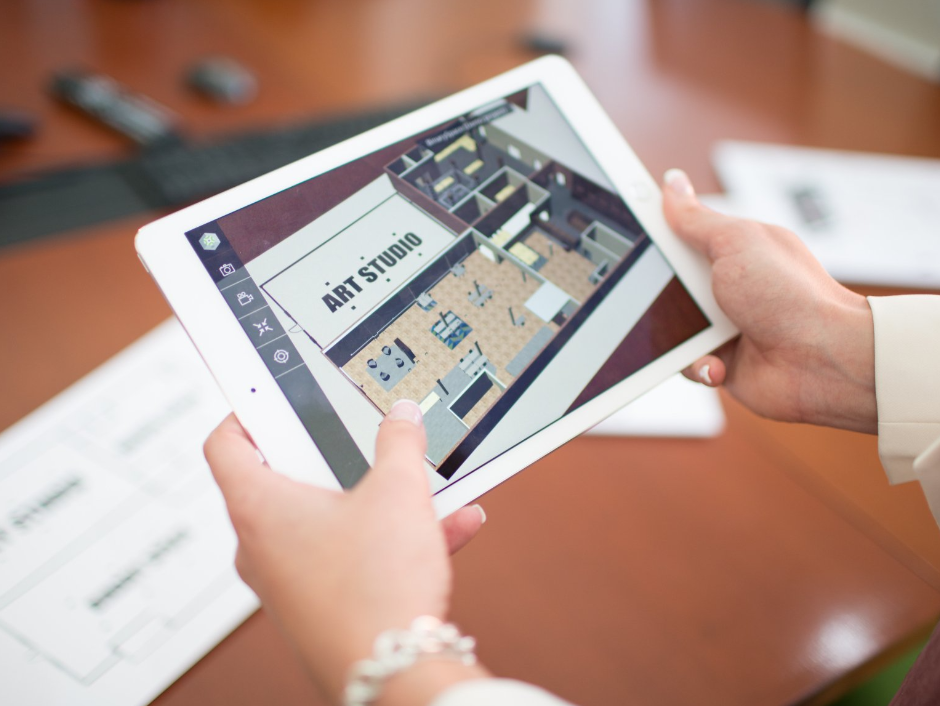 A person is holding a tablet that says art studio on it