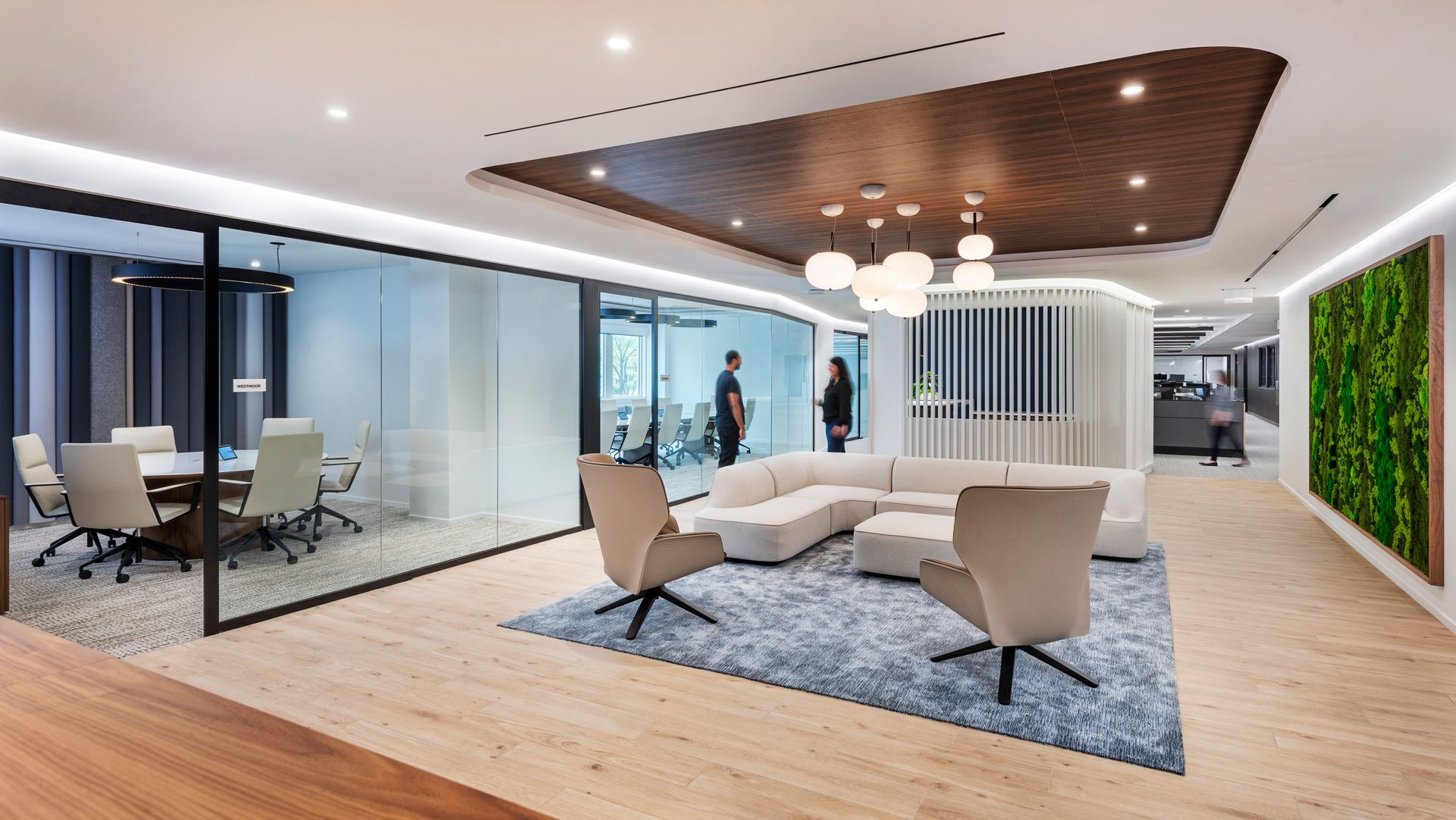 A living room with a couch , chairs , and a conference room.