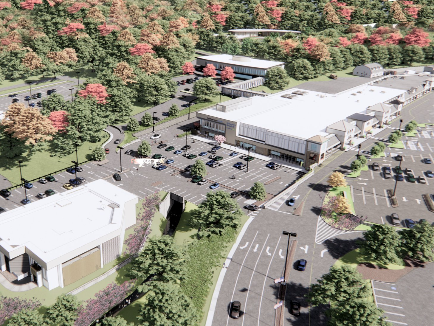An aerial view of a large building surrounded by trees and a parking lot.