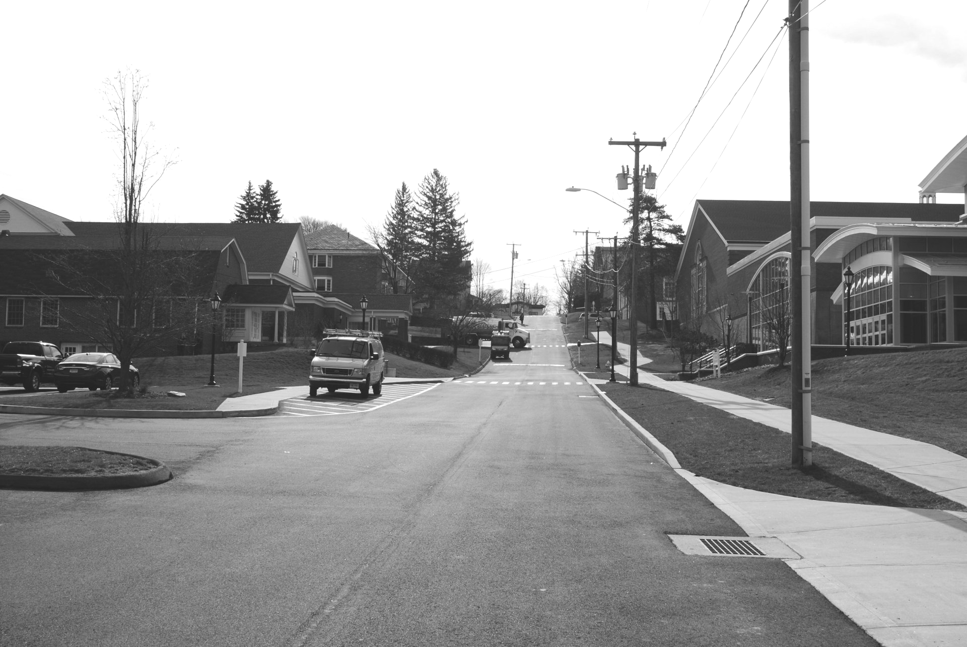 A black and white photo of a residential street