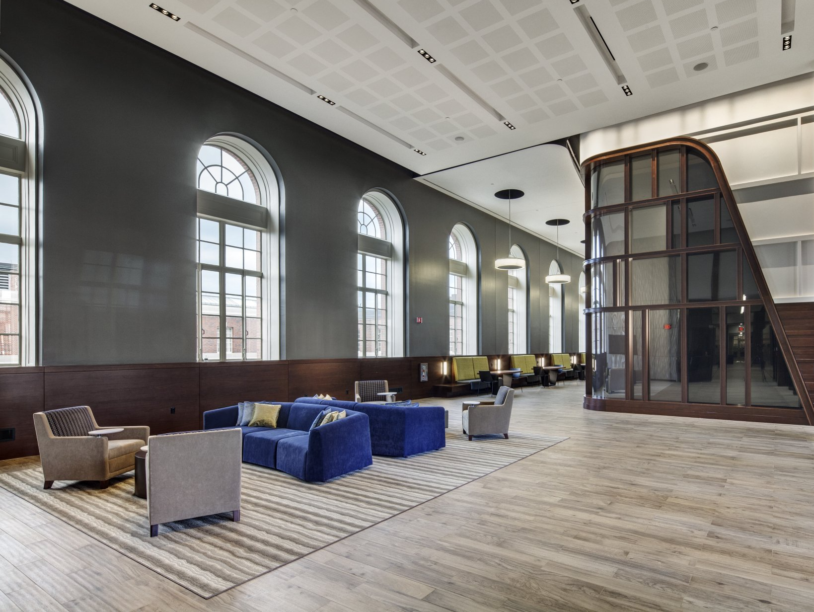 A large room with a lot of windows and furniture