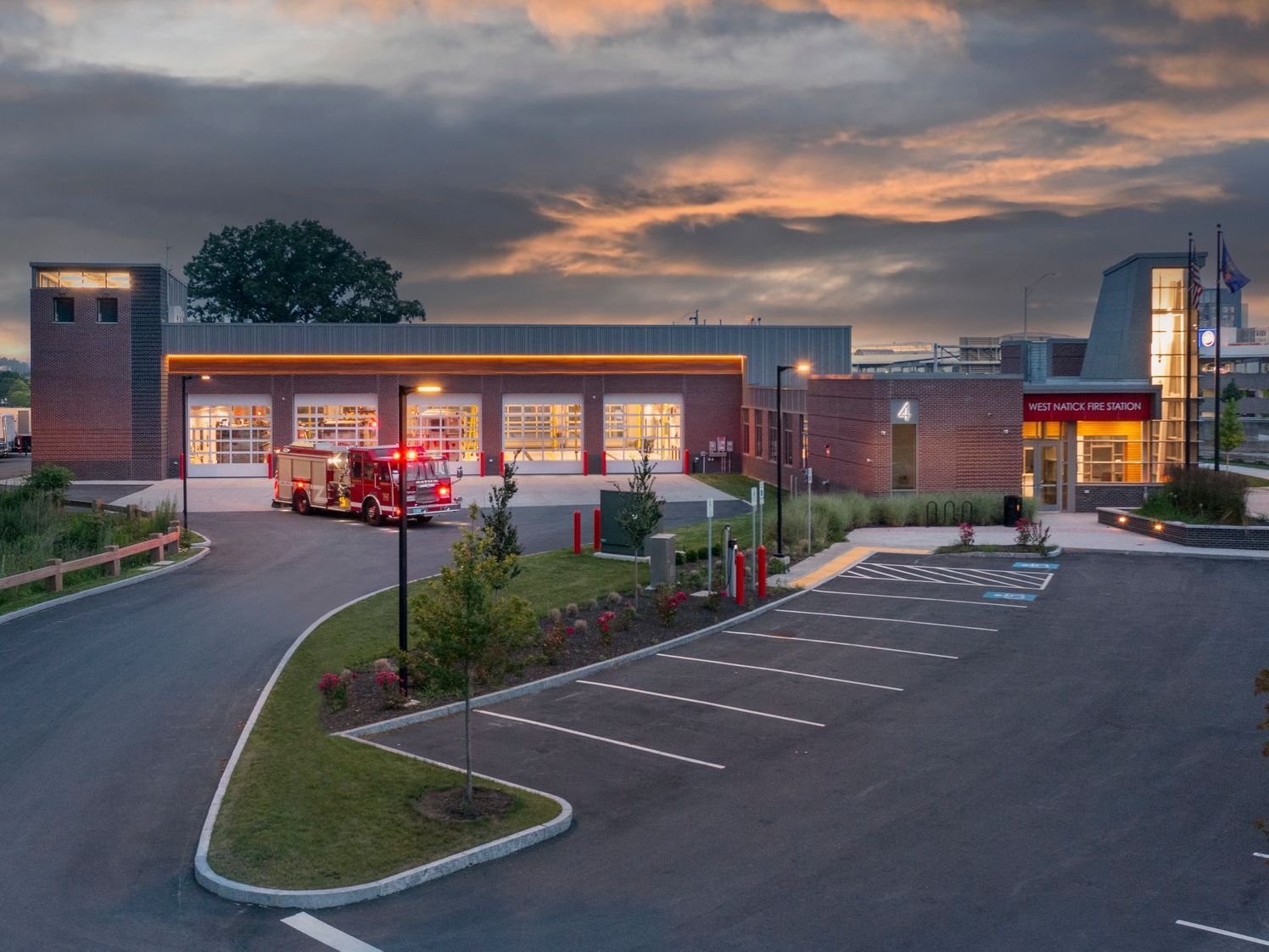 A fire truck is parked in front of a fire station.