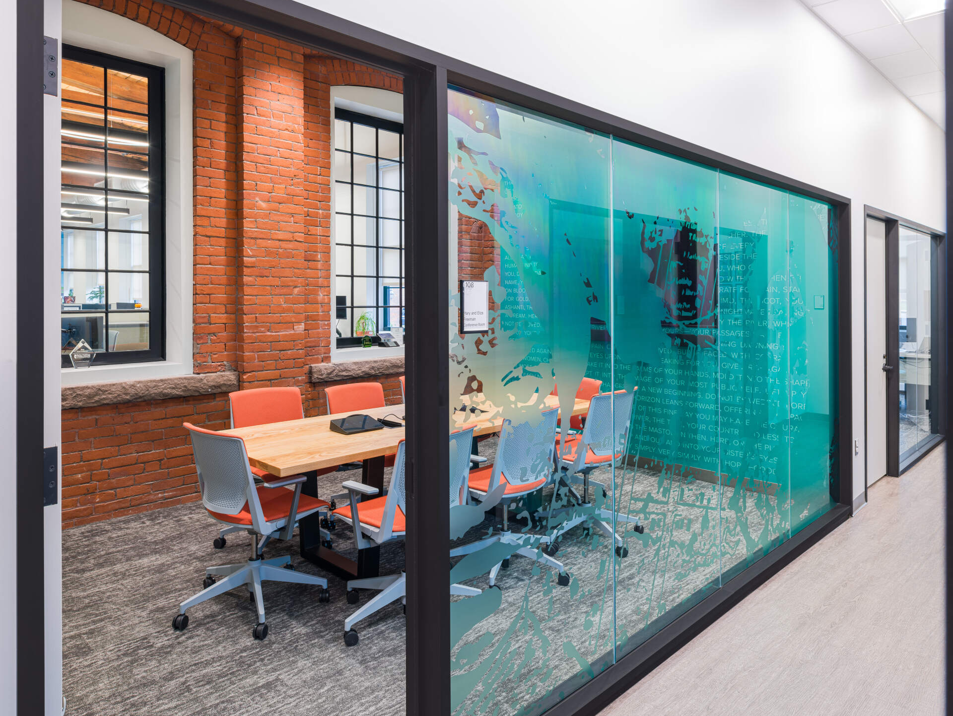 There is a conference room with a table and chairs in it.