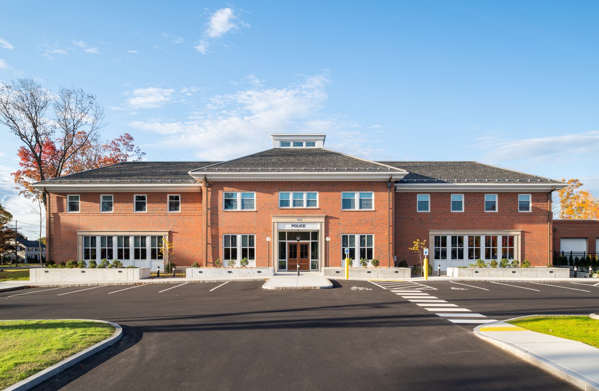 A large brick building with a parking lot in front of it