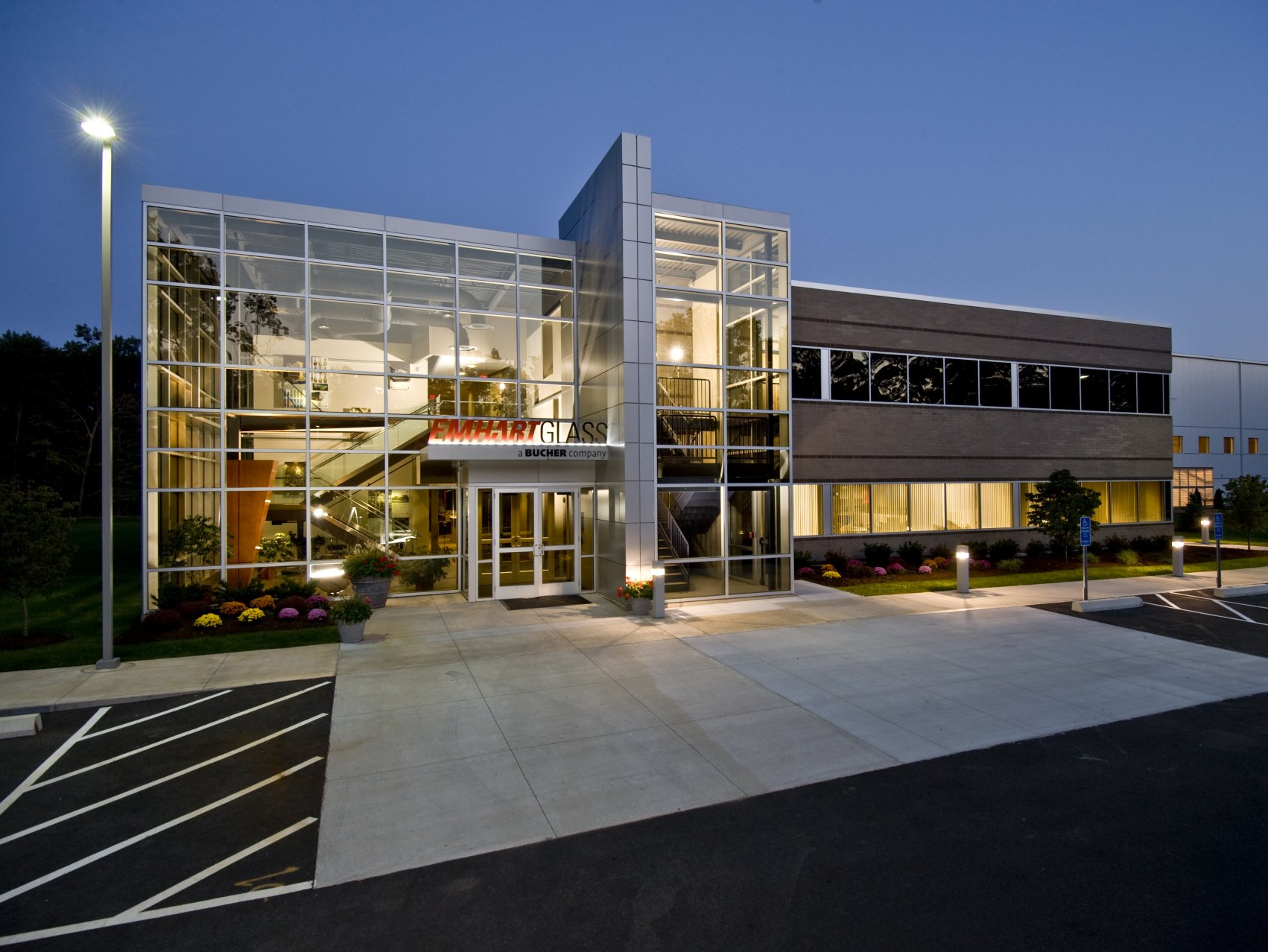 A large building with a lot of windows is lit up at night