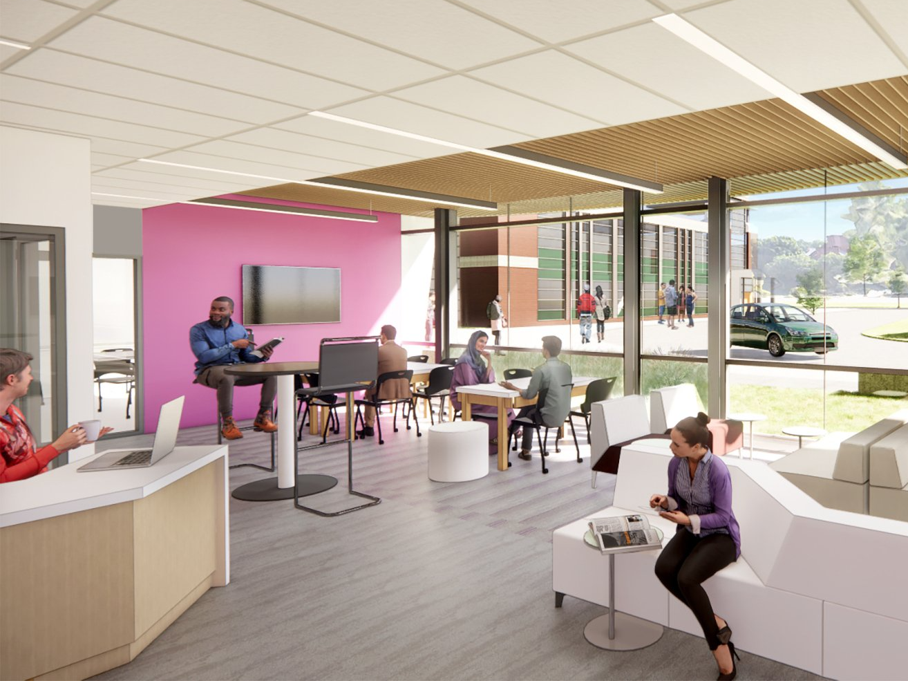 A group of people are sitting at tables in a room with a pink wall.
