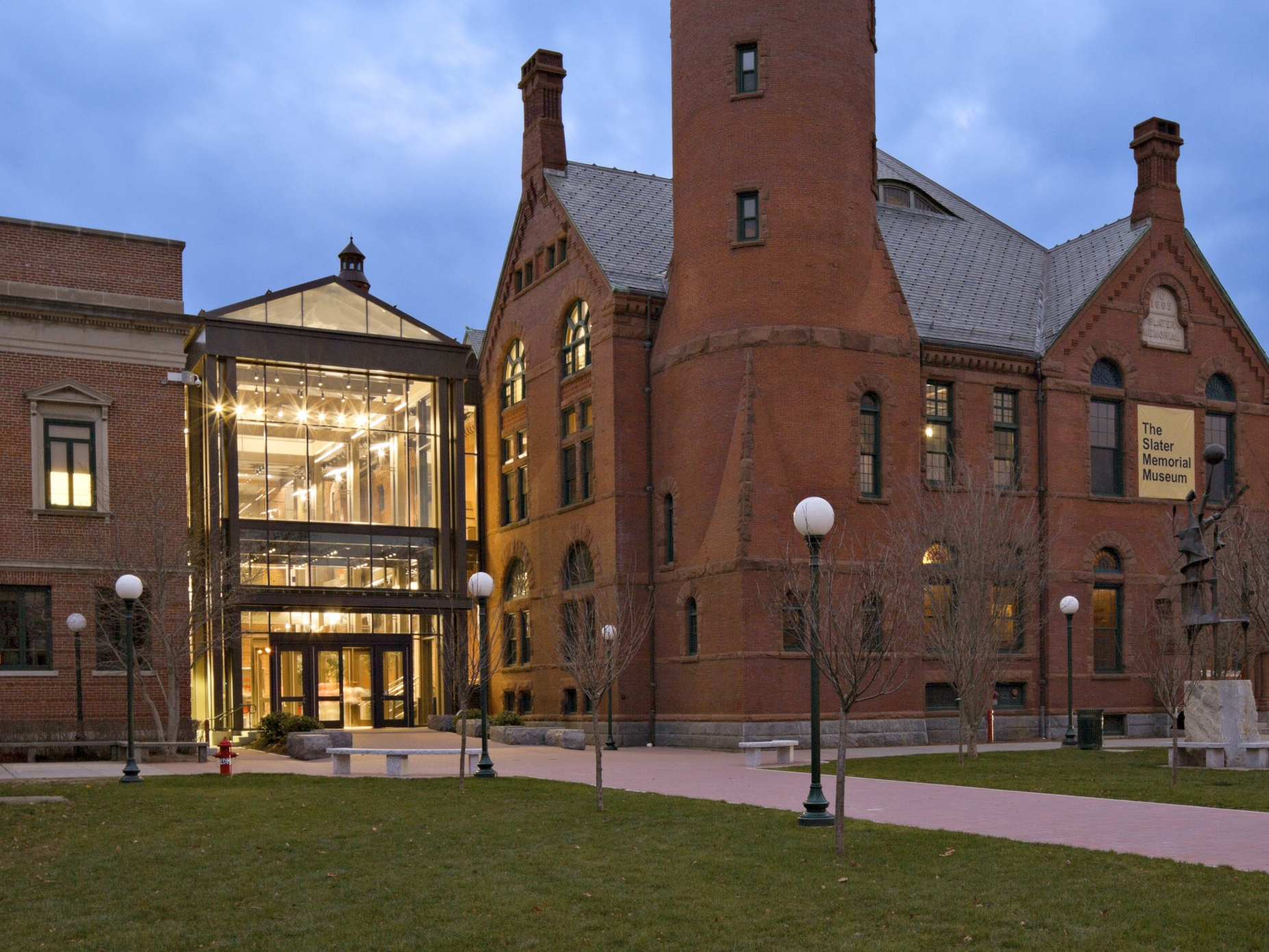 A large brick building with a clock tower and a sign on the side that says ' a ' on it