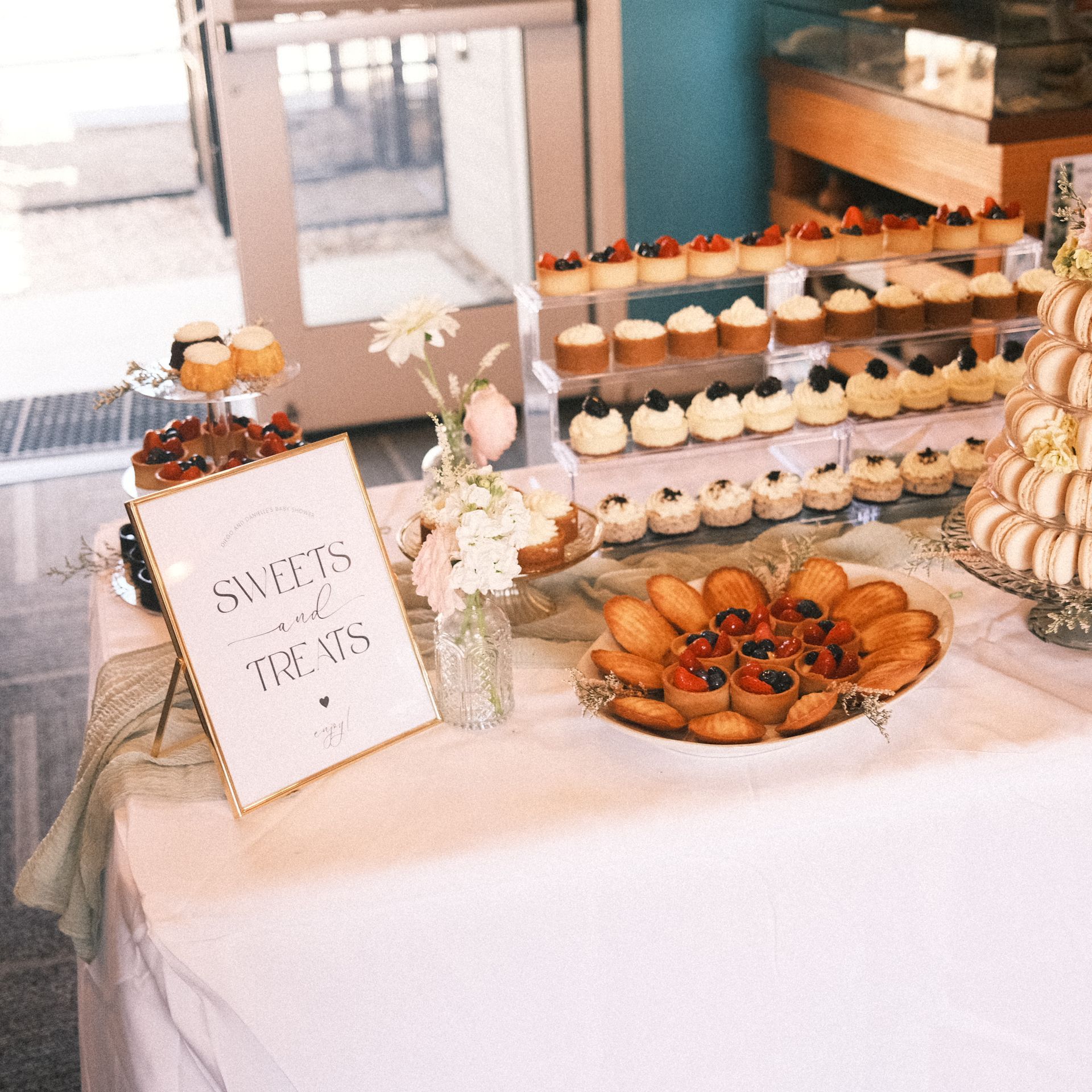 Dessert table with treats, sign that reads 