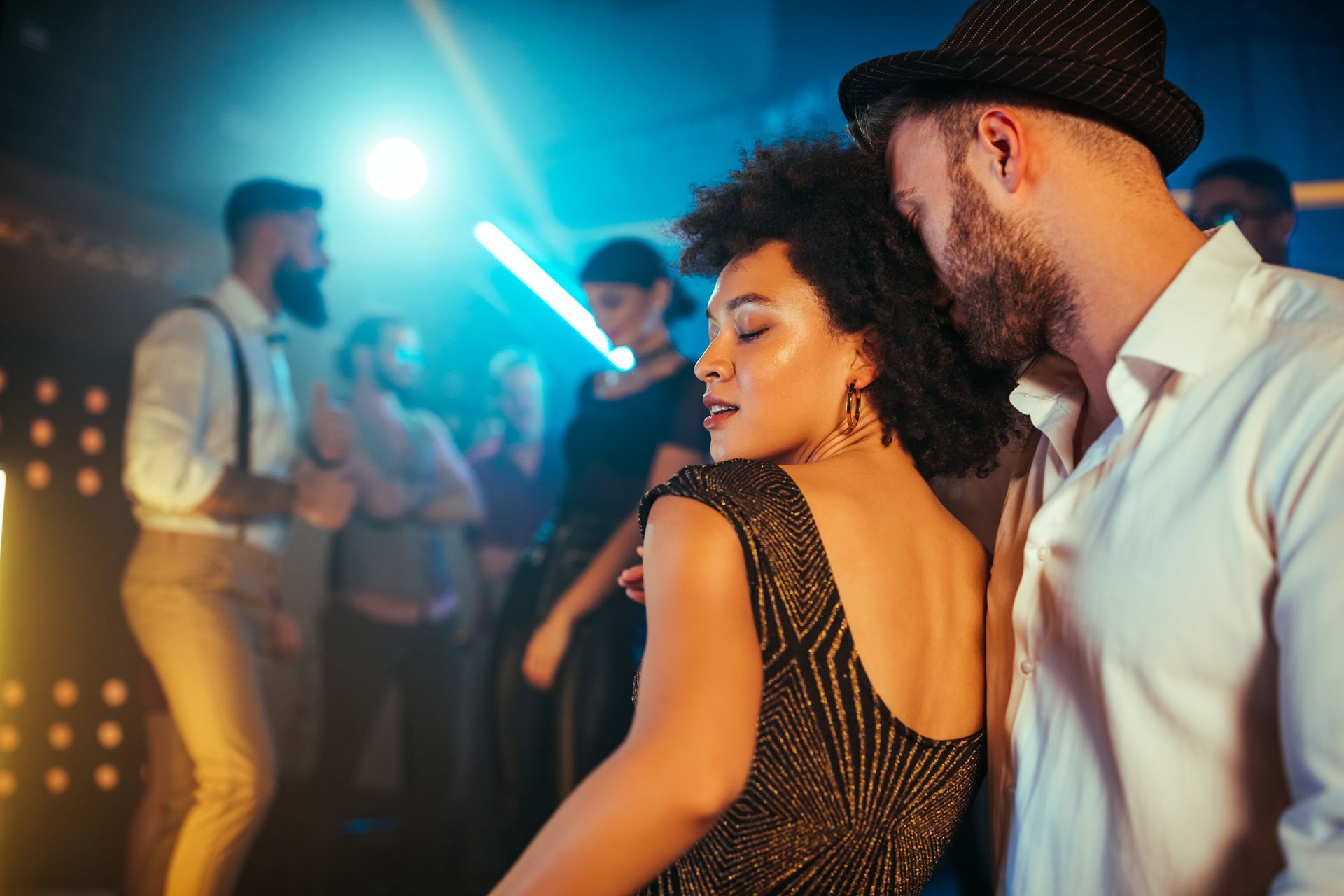 A man and a woman are dancing together in a club.