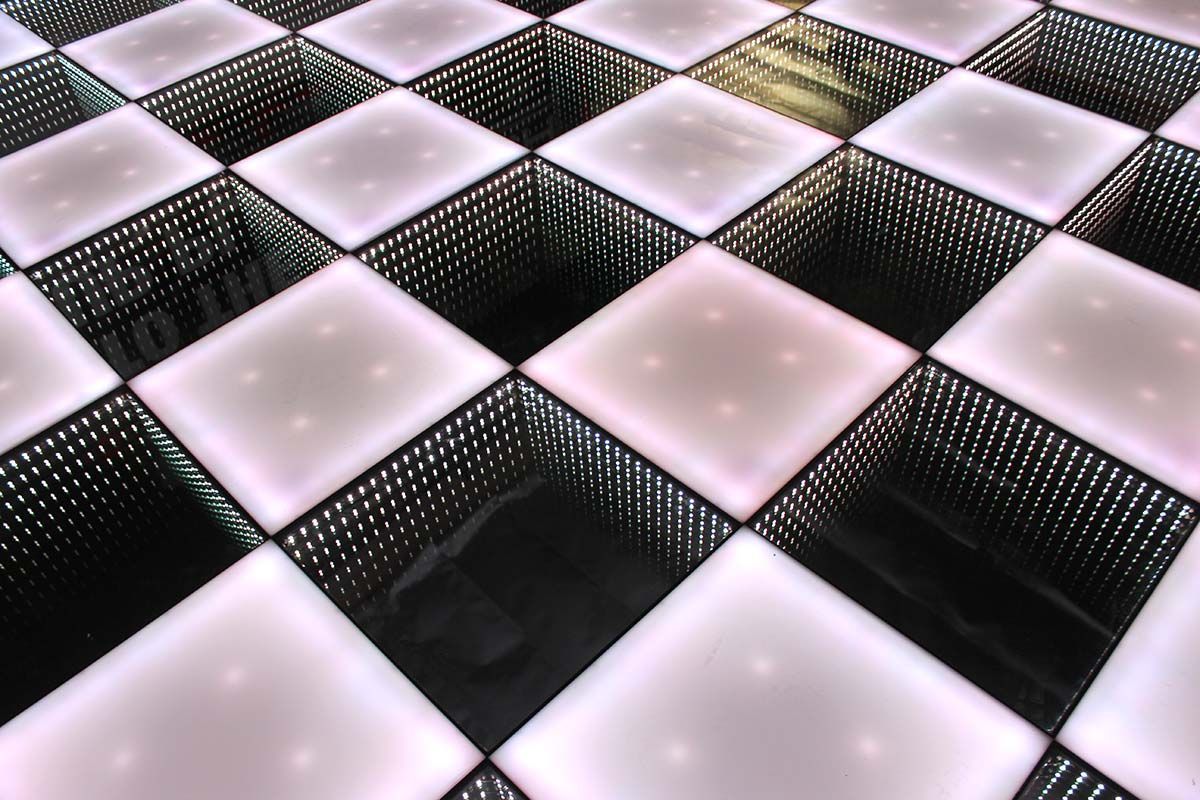 A checkered floor with a reflection of a person in the middle