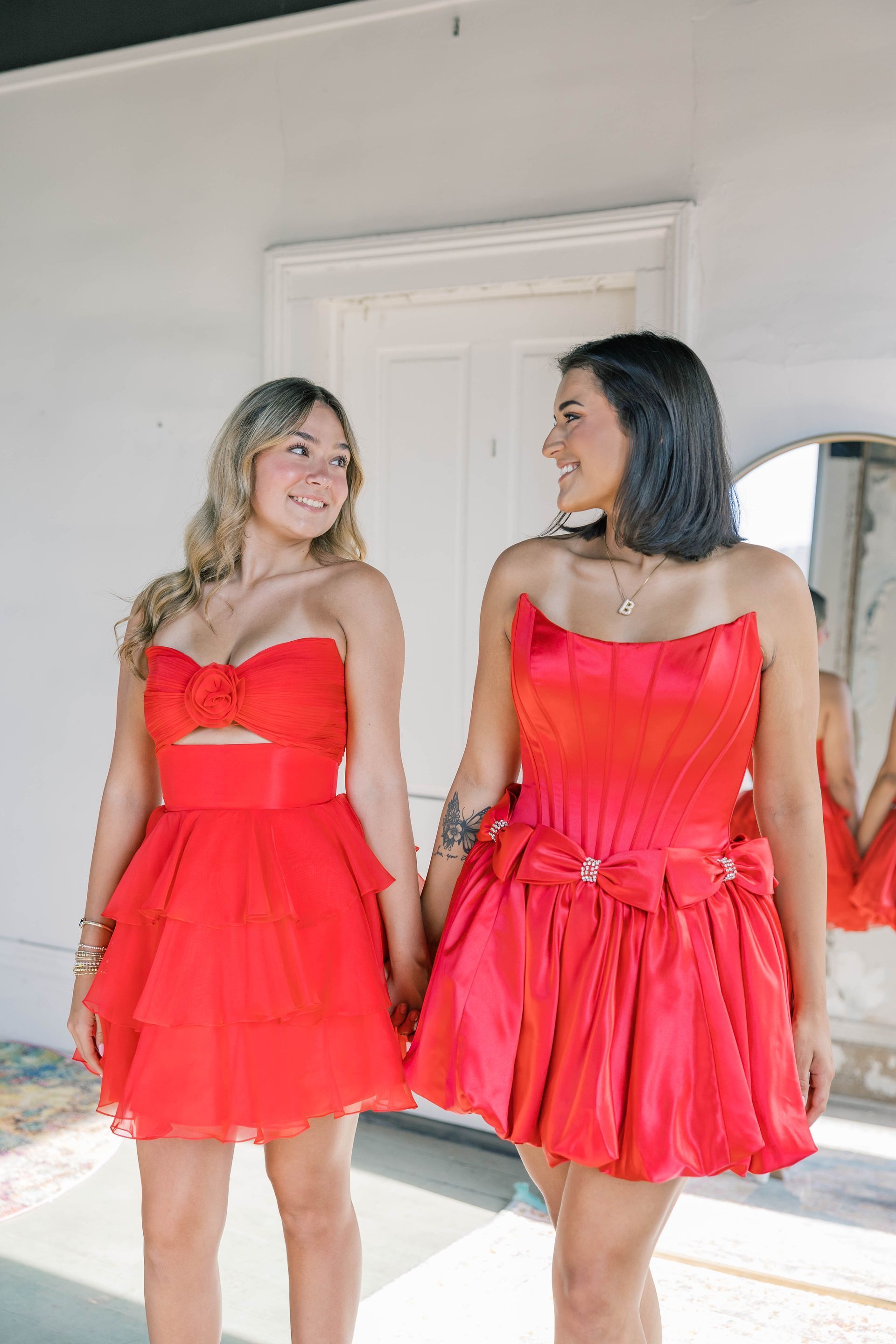 A woman in a green dress is standing in a white room.